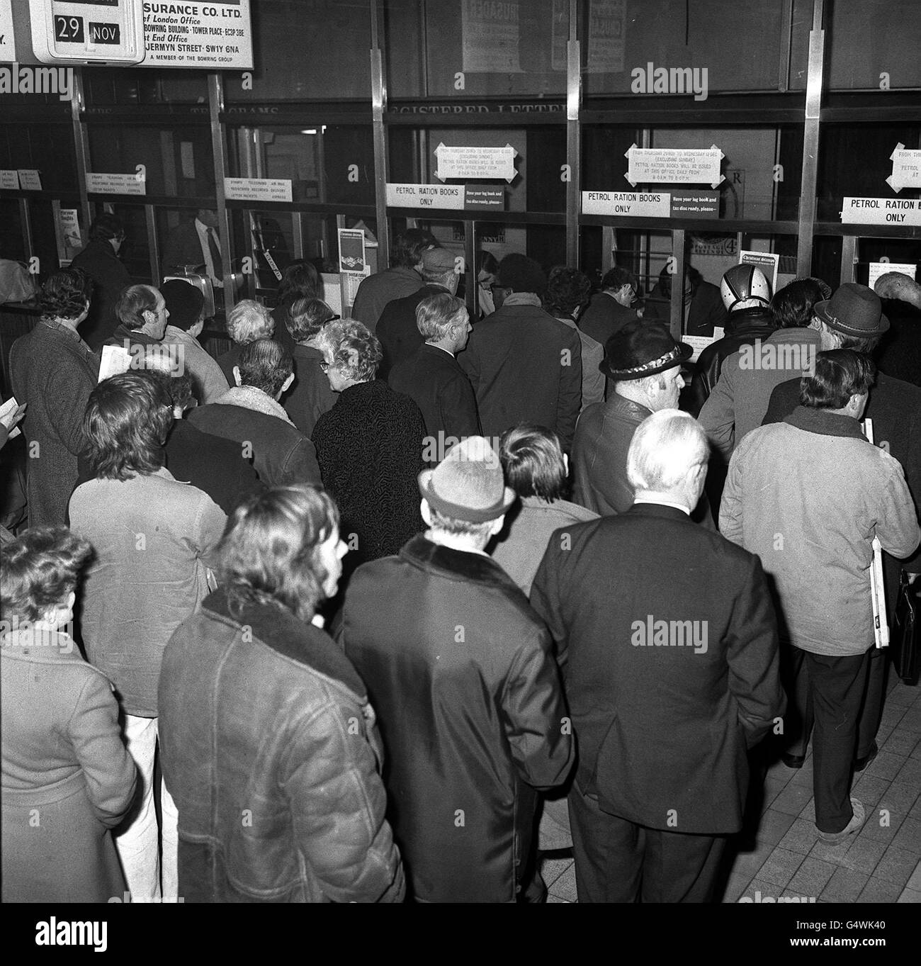 Queues at the counter in the Trafalgar Square Post Office when issuing of motor fuel ration books started at 8am today. In the line up where vehicle owners whose surnames begin with A or B. Stock Photo