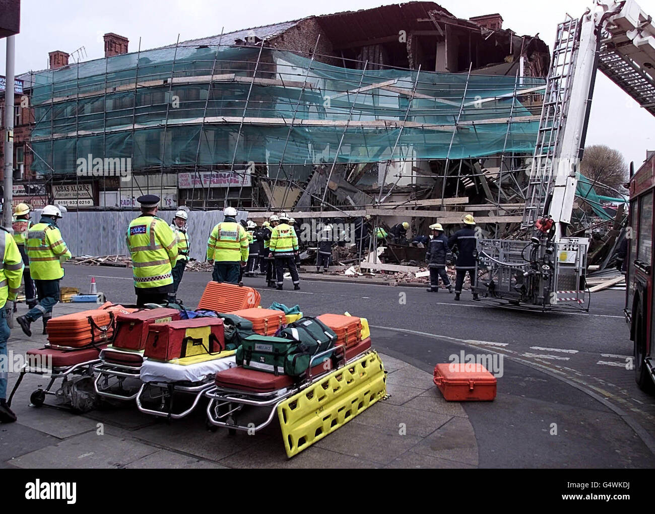 Firefighters search through the rubble of collapsed building in bootle ...