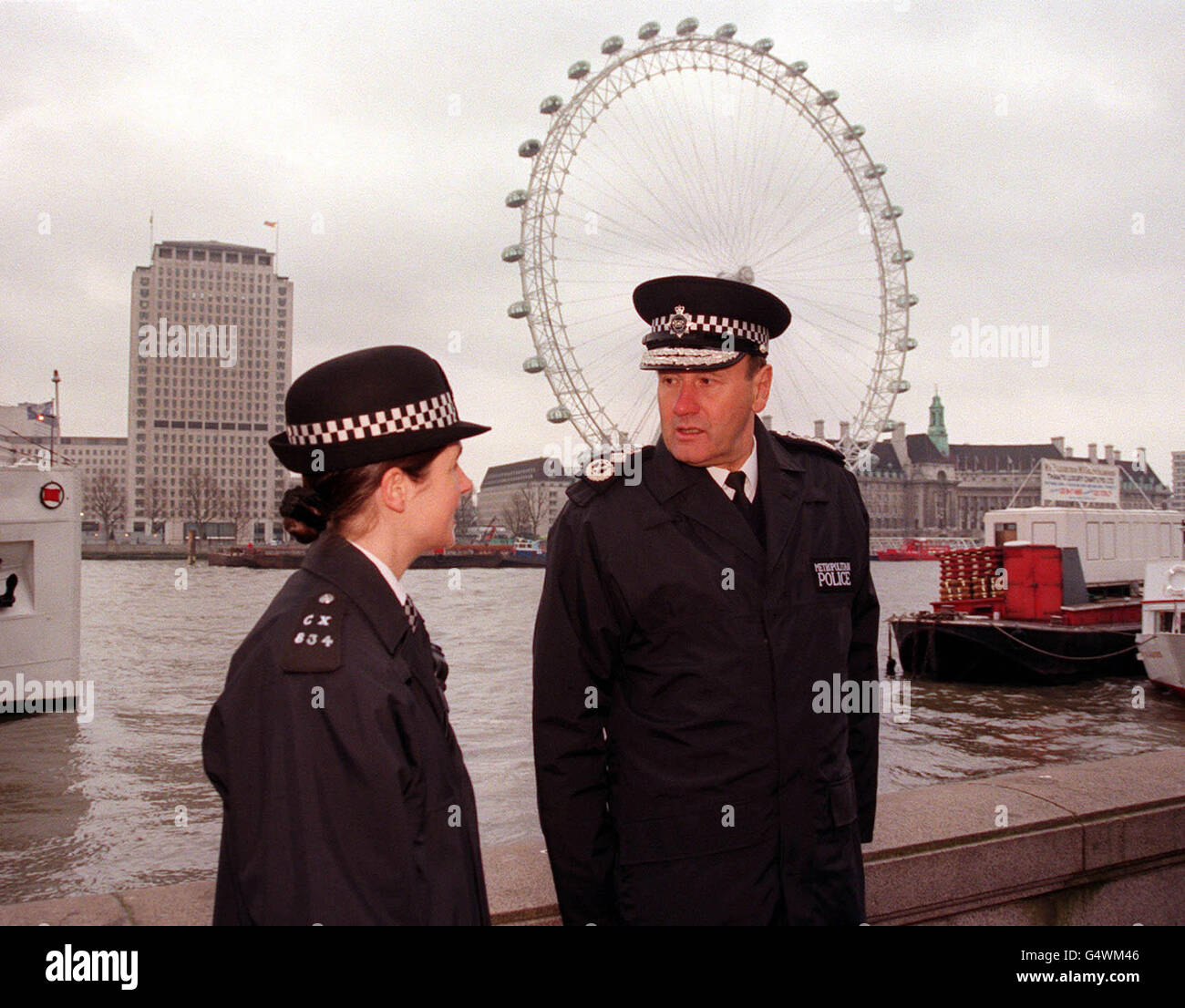 The new Commissioner of the Metropolitan Police, Sir John Stevens, talks to a female police officer, on his first day in charge of London's bobbies. Sir John has issued a 10-point police plan to cut crime and bureaucracy and pledged to make London a safer place. * He has also warned of a police recruitment crisis because of poor pay and the battering the force received over the bungled Stephen Lawrence murder investigation. Stock Photo