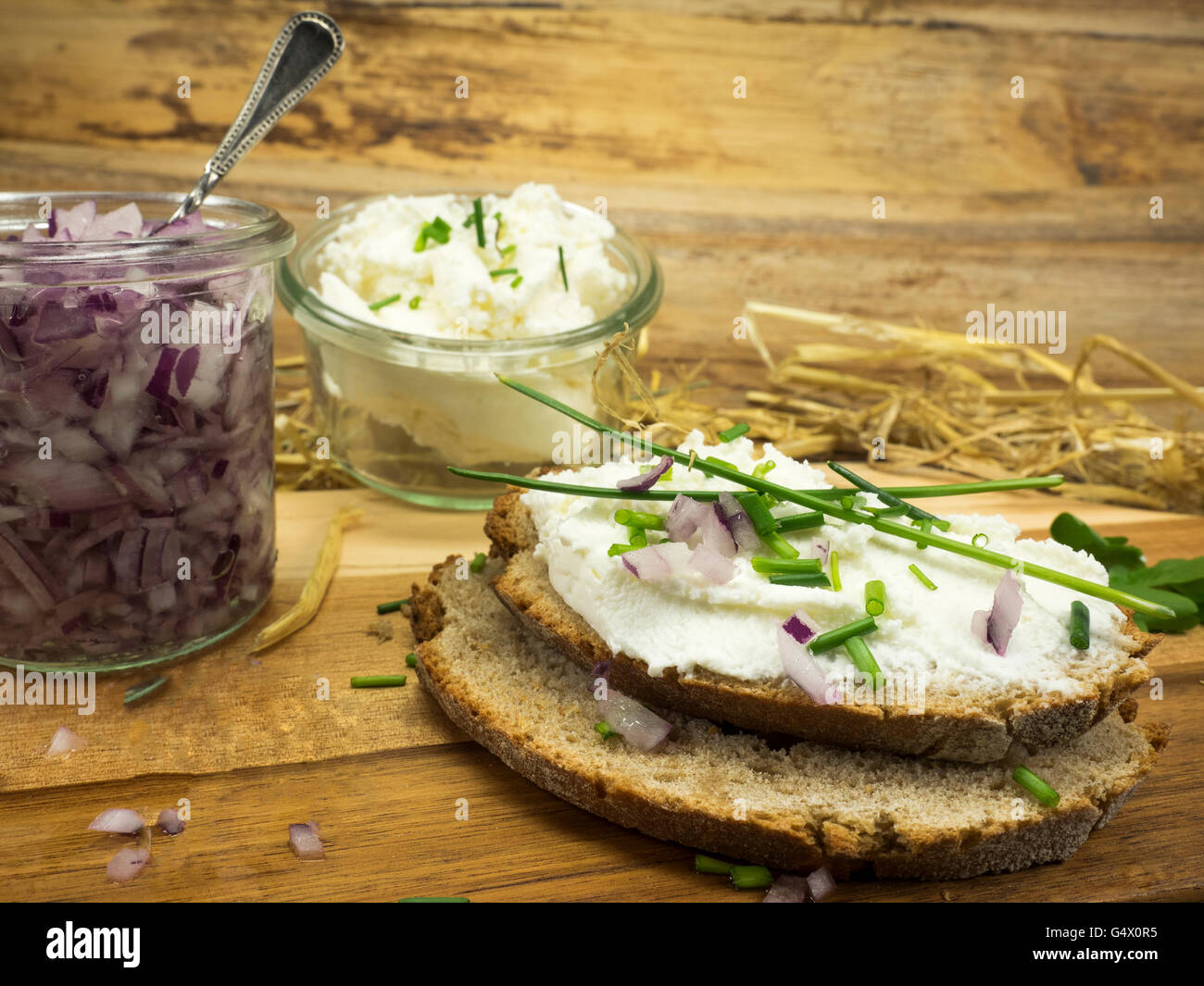 Fresh goat cheese with herbs and onions Stock Photo