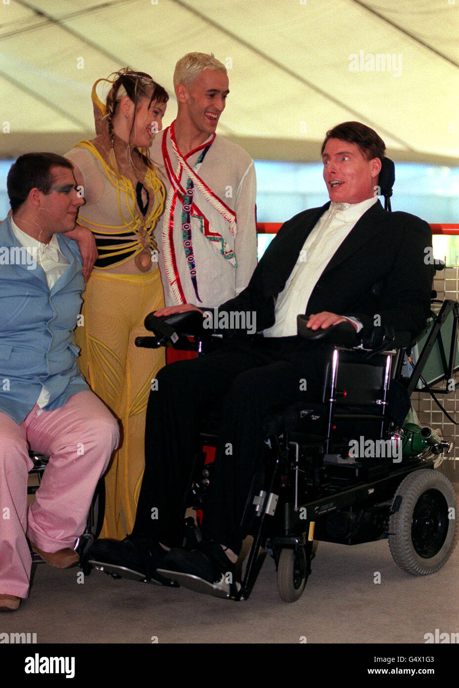 'Superman' actor Christopher Reeve with dancers (L-R) Colin White, Corinne Pierre and Matt Costain, during a visit to the Millennium Dome in Greenwich, London. This is the first trip the actor has made abroad since the riding accident which paralysed him. Stock Photo