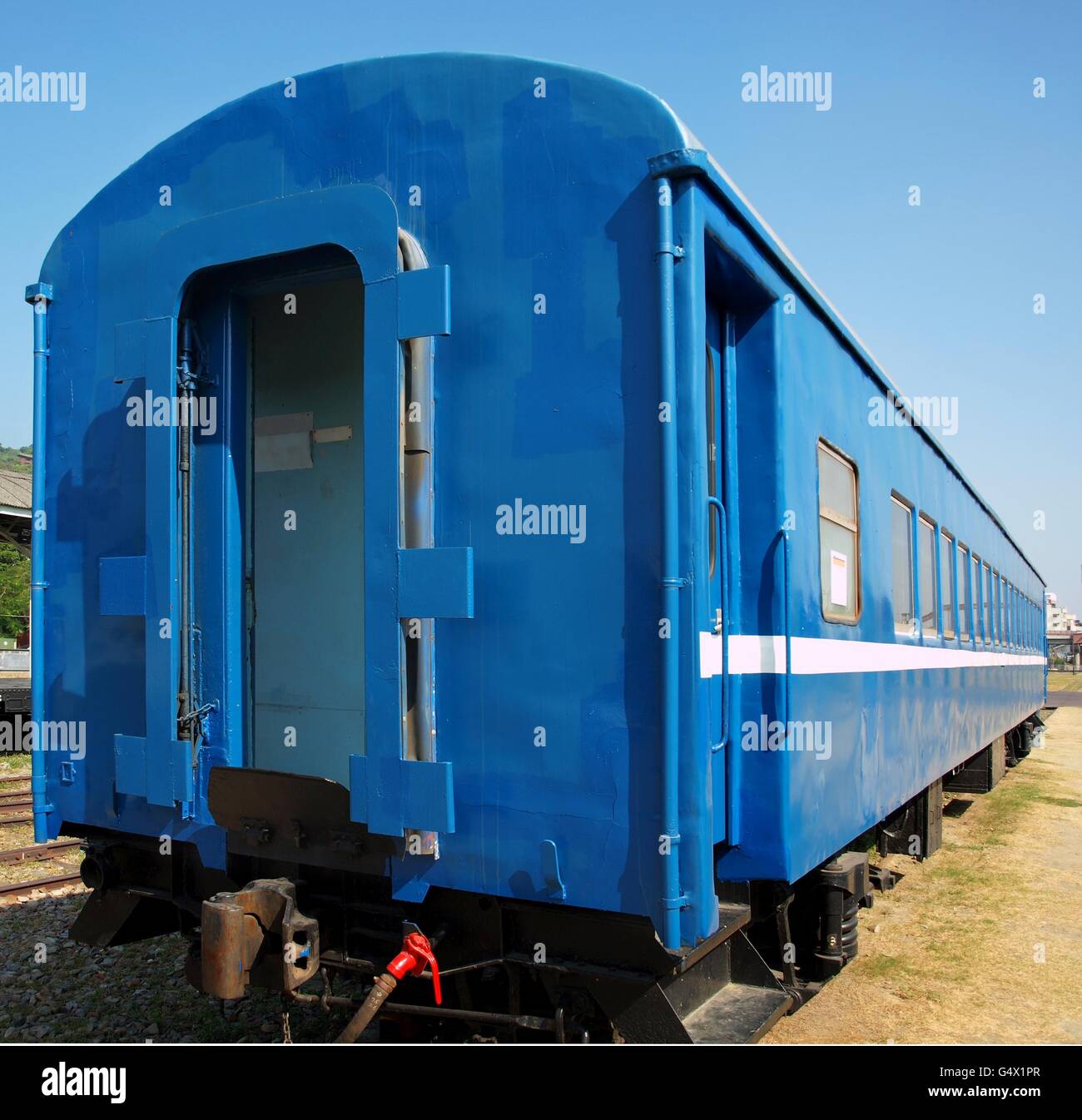 A vintage train carriage that has been freshly painted in bright blue Stock Photo