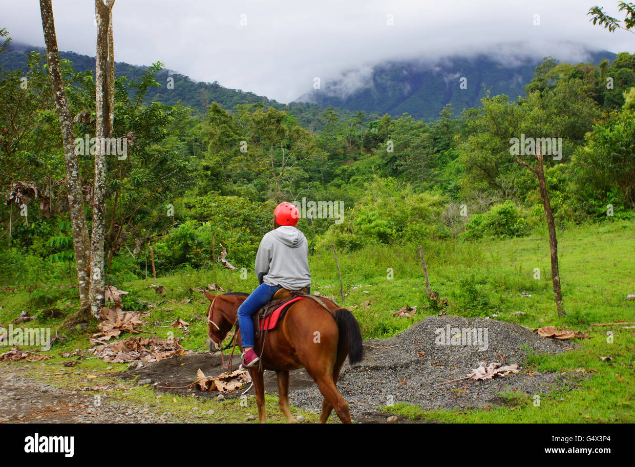 Excursion in the mountains on horseback. Province of Alajuela, canton of San Carlos,   Arenal, Costa Rica Stock Photo