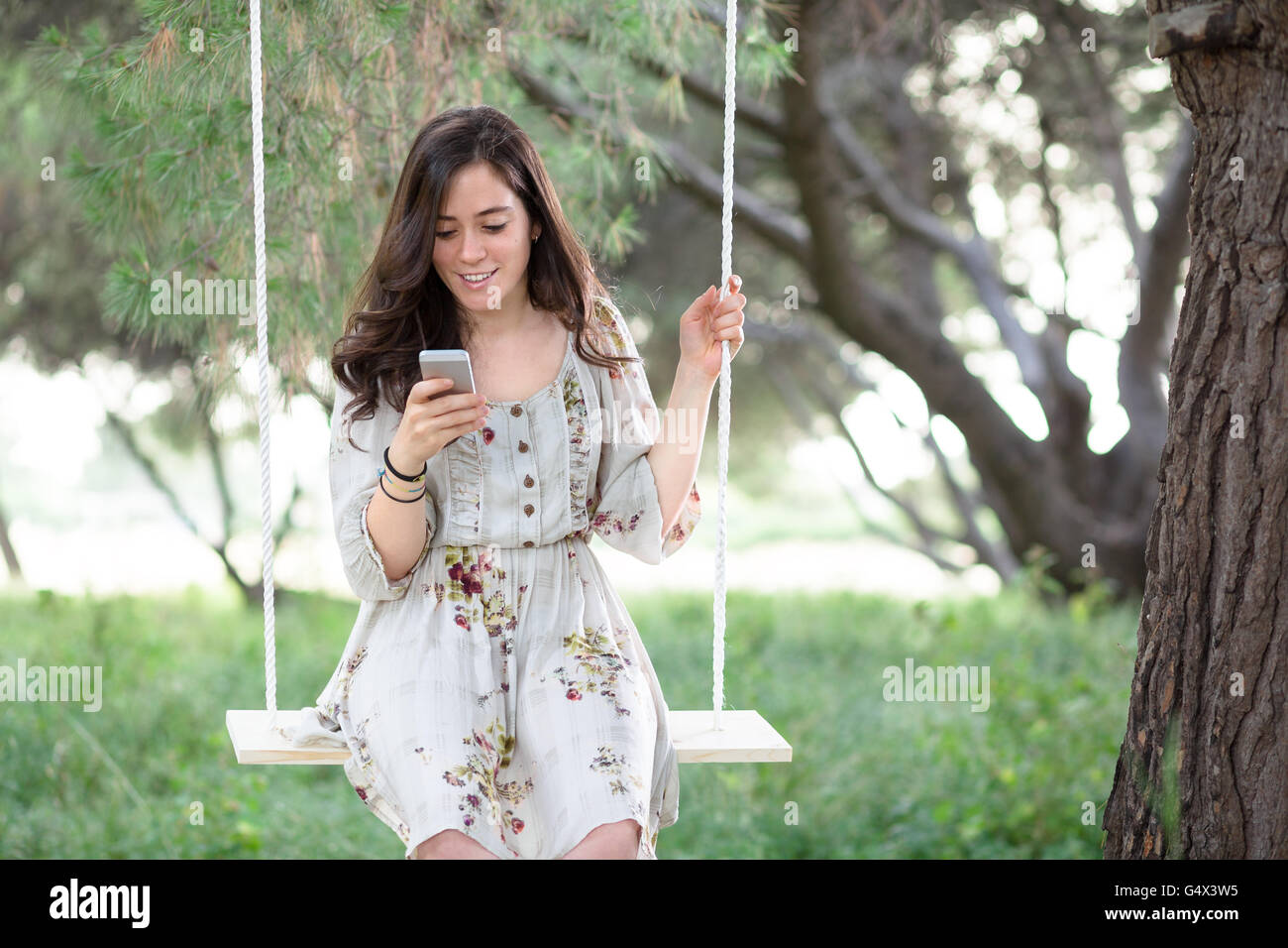 Woman on rope swing hi-res stock photography and images - Alamy