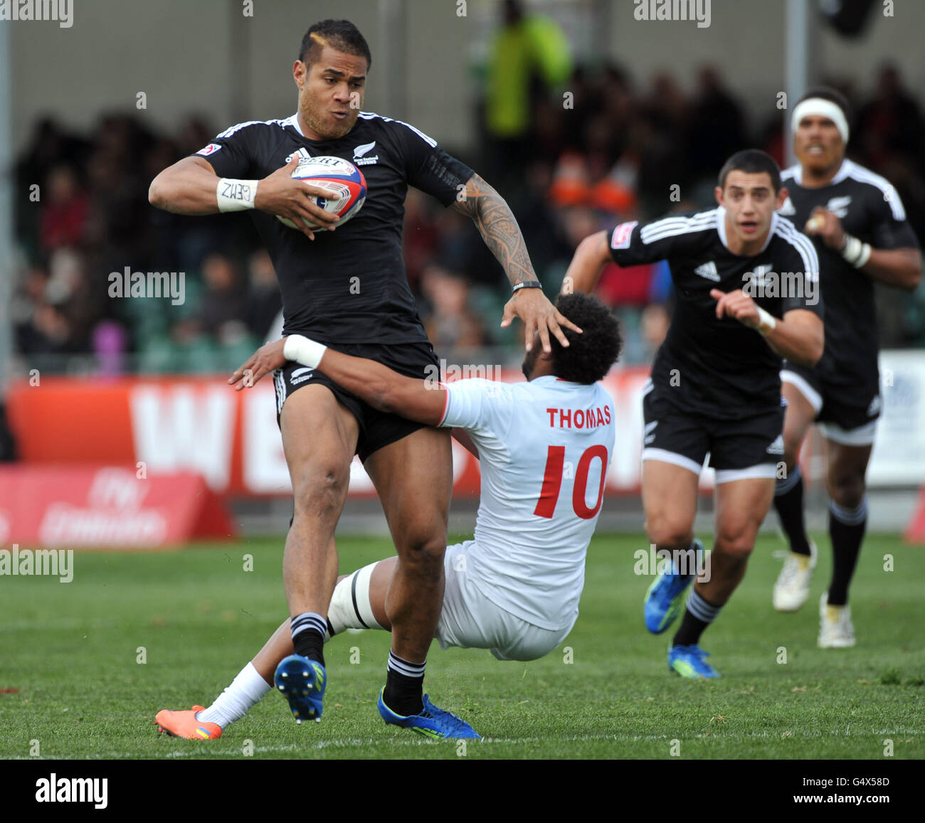 New Zealand's Frank Halai is tackled by France's Teddy Thomas on his way to scoring a try during the Glasgow Sevens at Scotstoun Stadium, Glasgow. Stock Photo