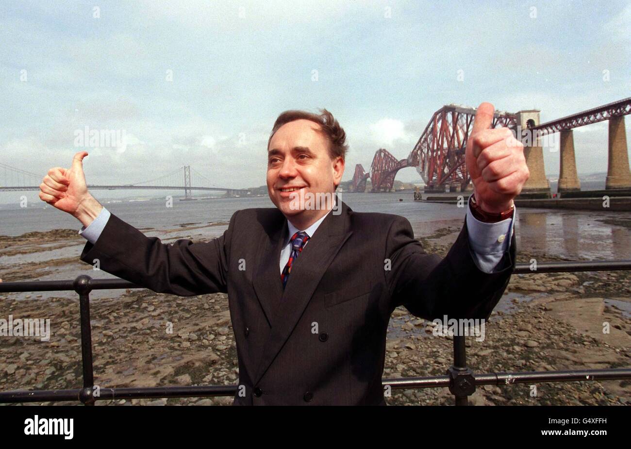 Scottish National Party leader Alex Salmond poses for photographs by the Forth rail bridge on the final day of his Scottish Parliament election campaign tour of Scotland. Stock Photo