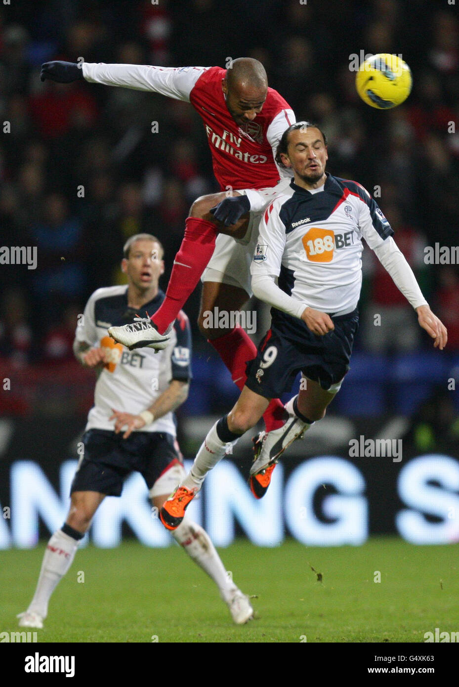 Arsenal's Thierry Henry (top) out-jumps Bolton Wanderers Tuncay Sanli  during the Barclays Premier League match at the Reebok Stadium, Bolton  Stock Photo - Alamy