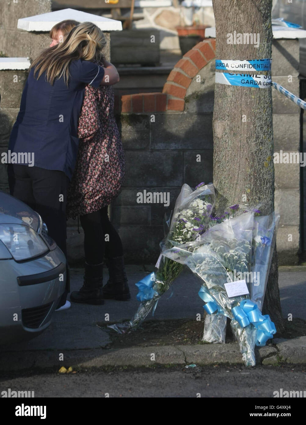 Friends and family (names not given) at the scene of the Cappagh Nua pub in the Finglas area of north Dublin where a man, named locally as Alan McNally, was shot dead at about 1am. Stock Photo