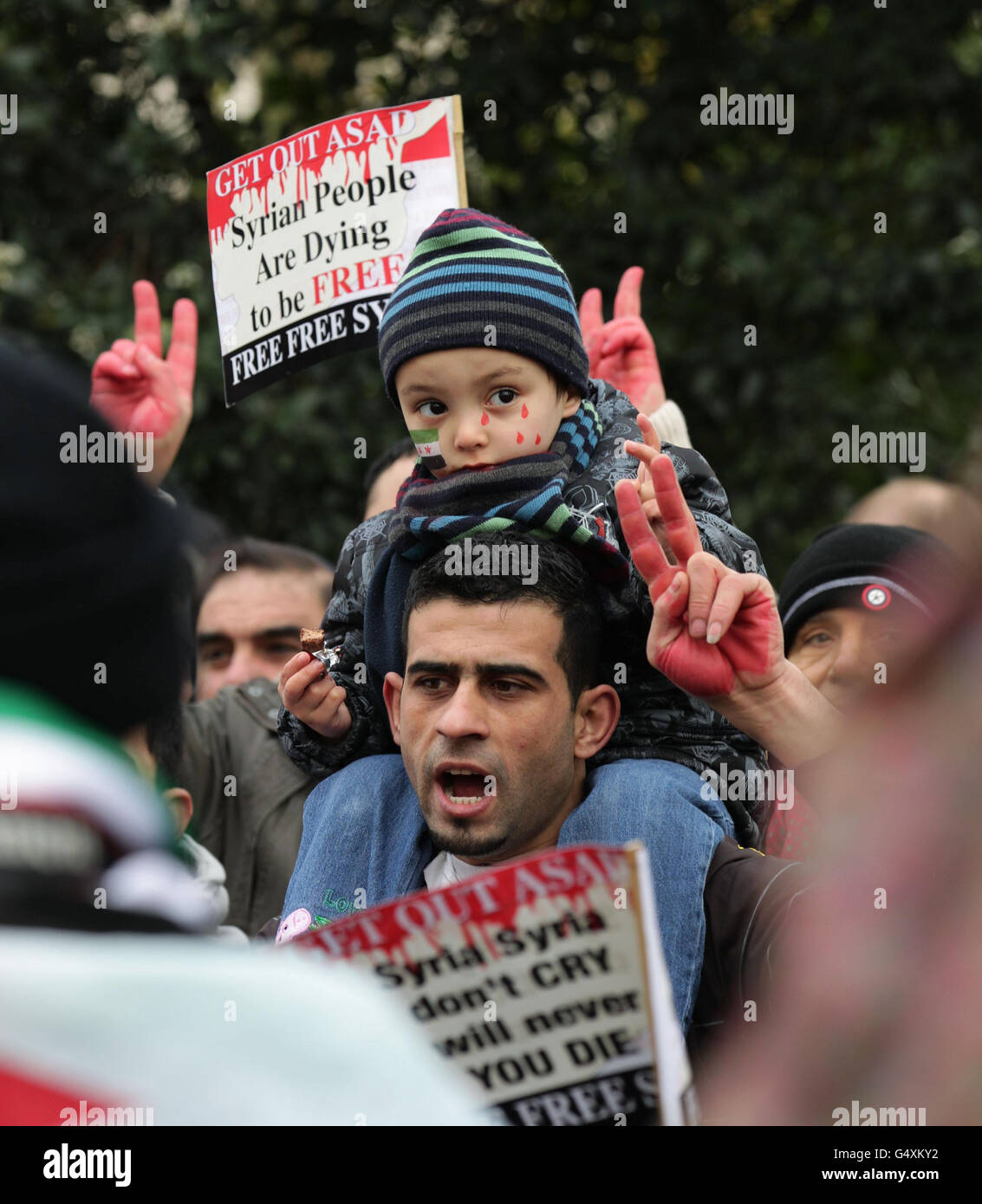 Protesters outside the Syrian Embassy in central London, amid reports of more than 200 people being killed in a deadly barrage in the city of Homs, Syria. Stock Photo