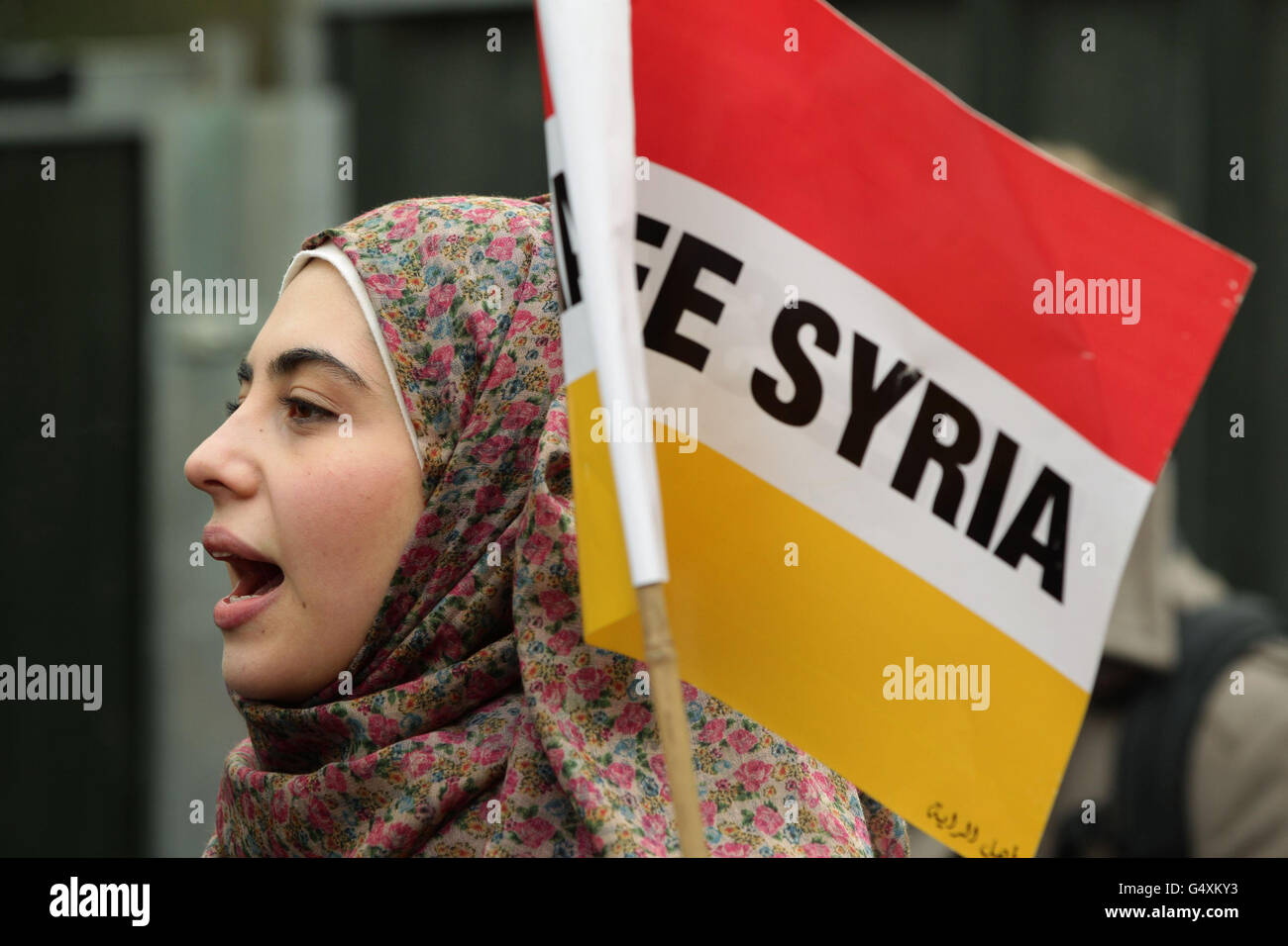 A protester outside the Syrian Embassy in central London, amid reports of more than 200 people being killed in a deadly barrage in the city of Homs, Syria. Stock Photo