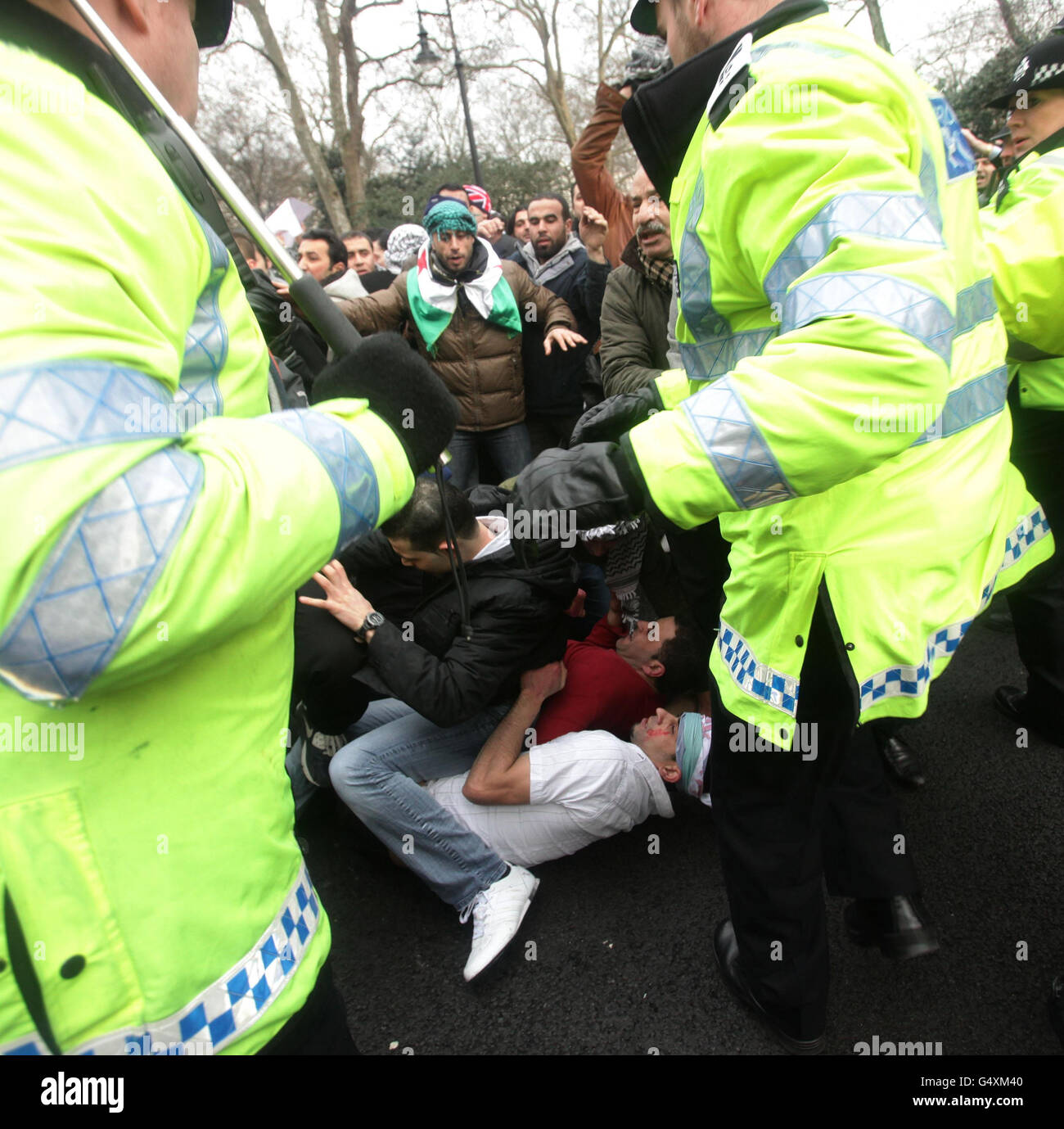 Protesters clash with police outside the Syrian Embassy in central London, amid reports of more than 200 people being killed in a deadly barrage in the city of Homs, Syria. Stock Photo