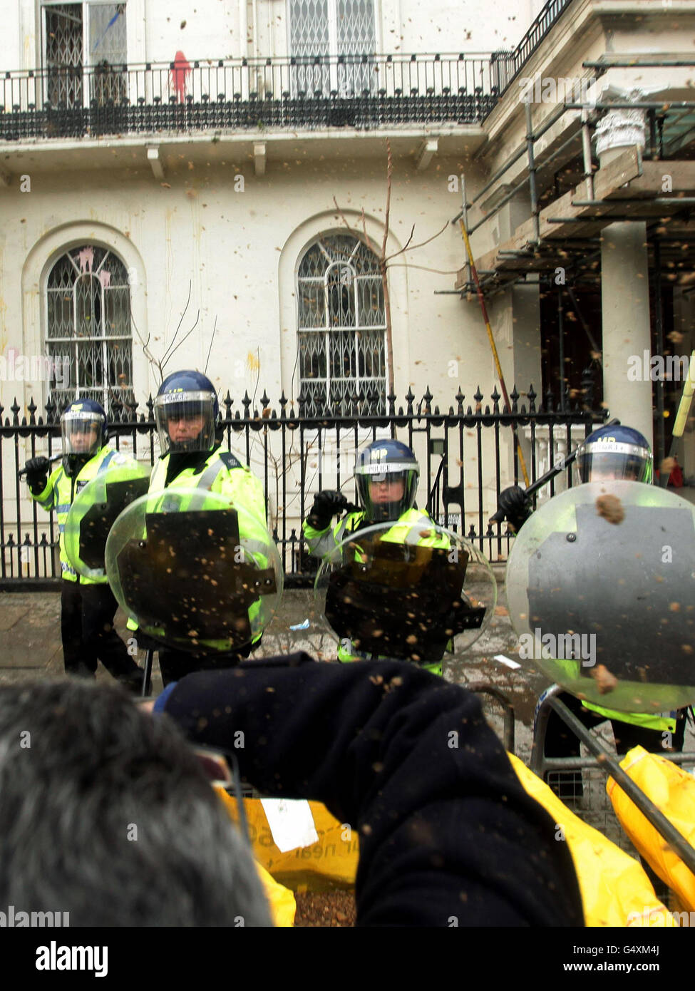Protesters clash with police outside the Syrian Embassy in central London, amid reports of more than 200 people being killed in a deadly barrage in the city of Homs, Syria. Stock Photo