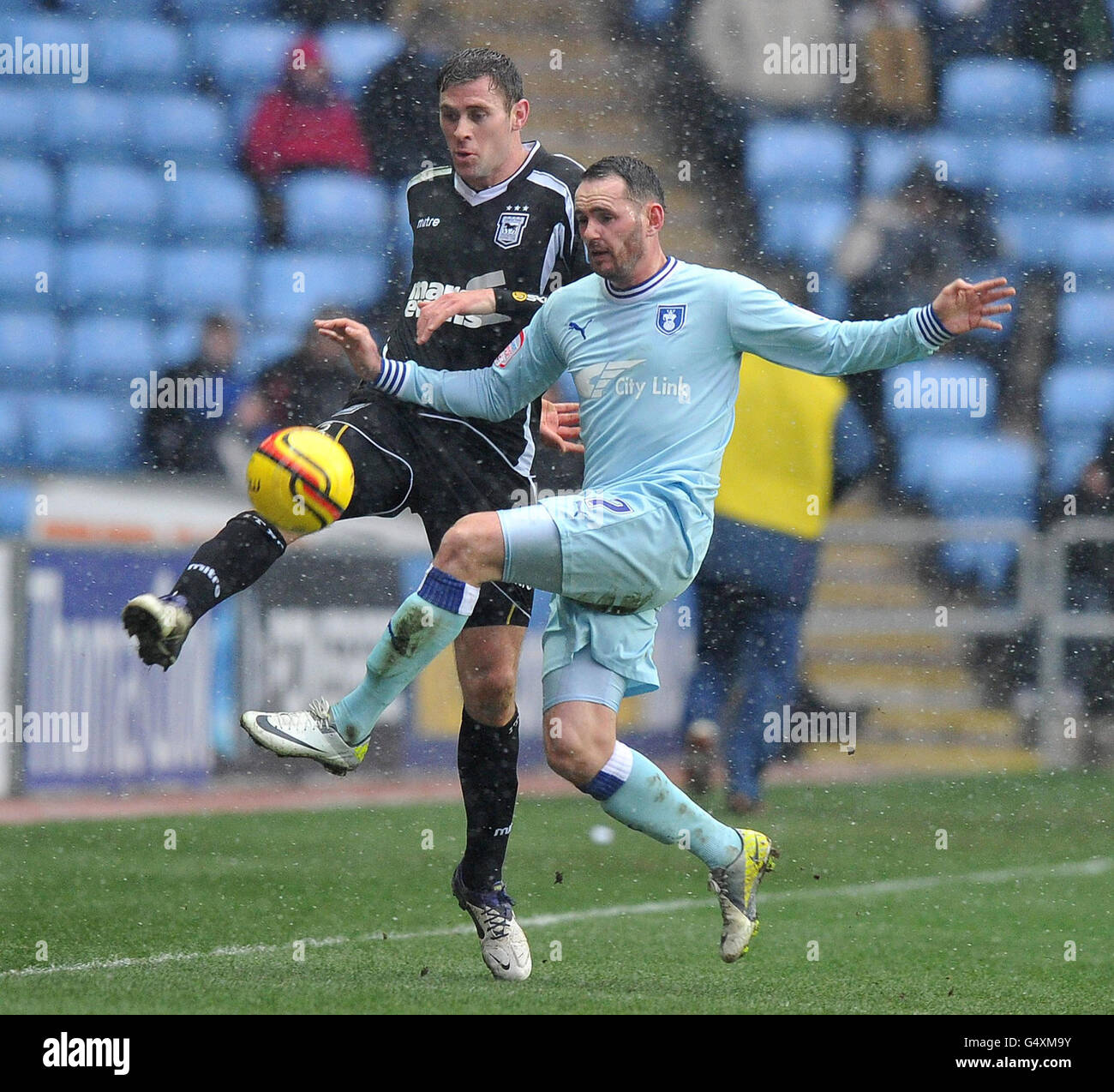Coventry City's David Bell and Ipswich Town's Andy Drury battle for the ball during the npower Football League League Championship match at the Ricoh Arena, Coventry. Stock Photo