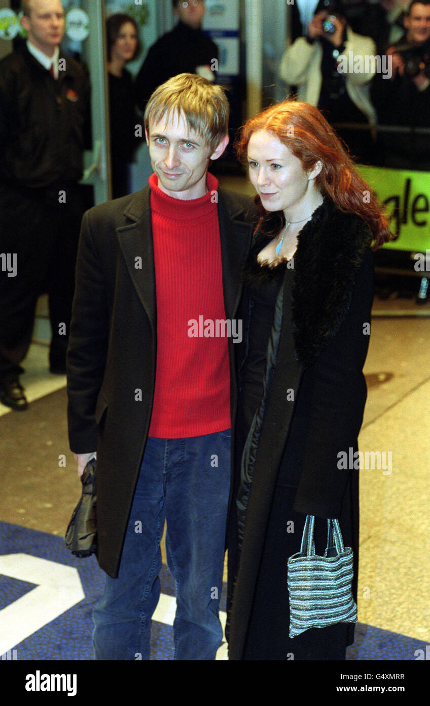 Neil Hannon, lead singer in the band The Divine Comedy and his wife Orla arrive for a special one-off celebrity screening of Withnail And I at the Odeon, Leicester Square, London. Stock Photo