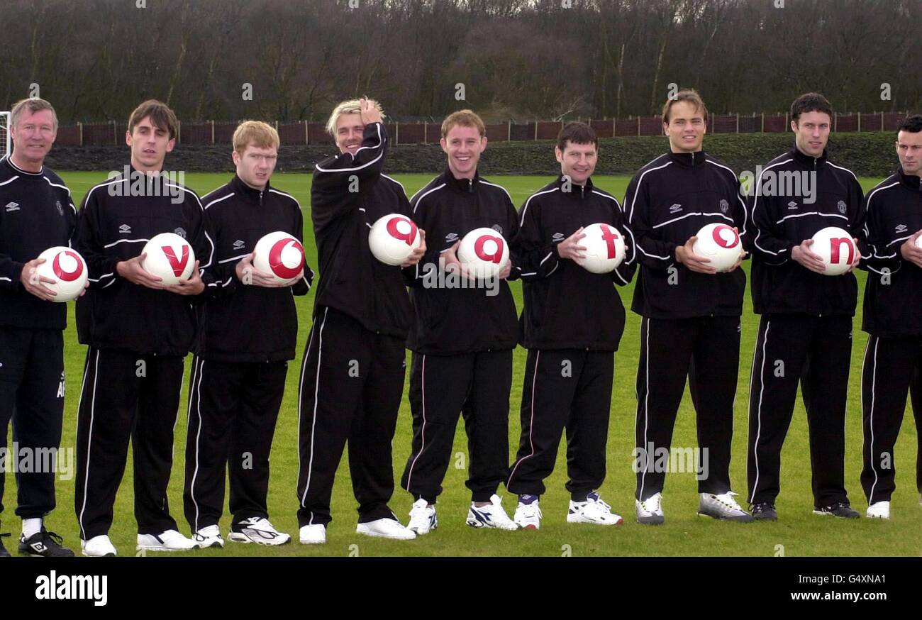 Manchester United manager Sir Alex Ferguson (left) and players help to unveil the club's new sponsor at the training ground in Carrington, Manchester. * Manchester United have agreed a record-breaking 30 million pound sponsorship deal with mobile phone company Vodafone. The four-year agreement, which begins in June, will see the firm's logo included on the team's shirts. Stock Photo