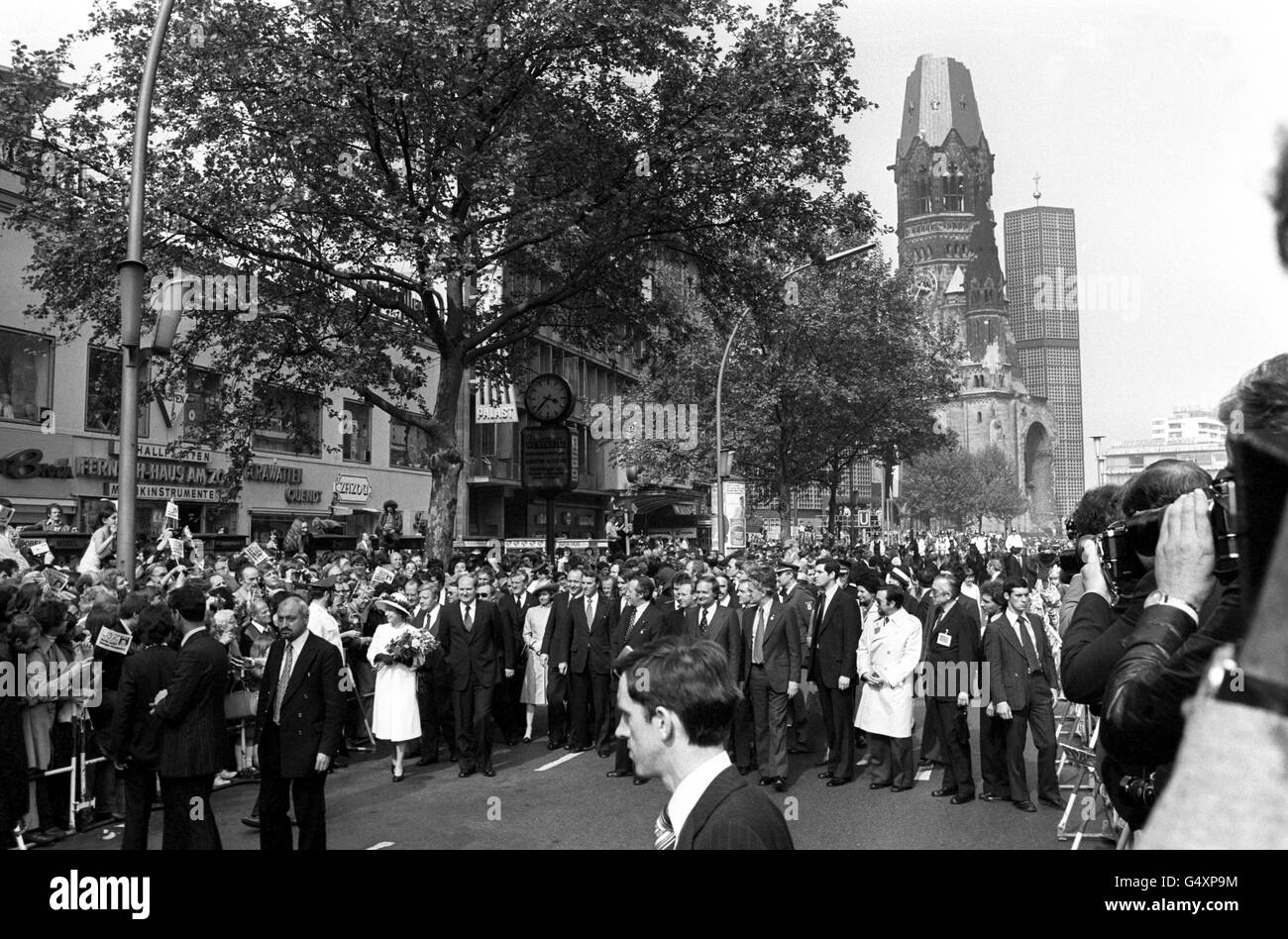 Queen Elizabeth II on a walkabout in West Berlin, after she made a speech close to the blitzed Kaiser Wilhelm Memorial Church (behind), during her State visit to West Germany. Stock Photo