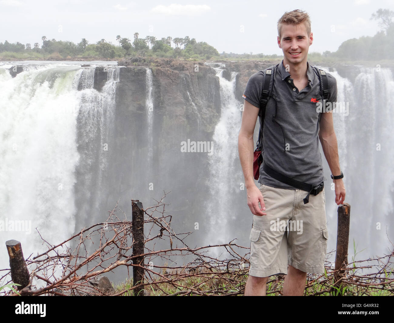 Zimbabwe, Matabeleland North, Hwange, Victoria Falls National Park, Victoria Falls, On Safari, Posing in front of the Victoria Falls Stock Photo