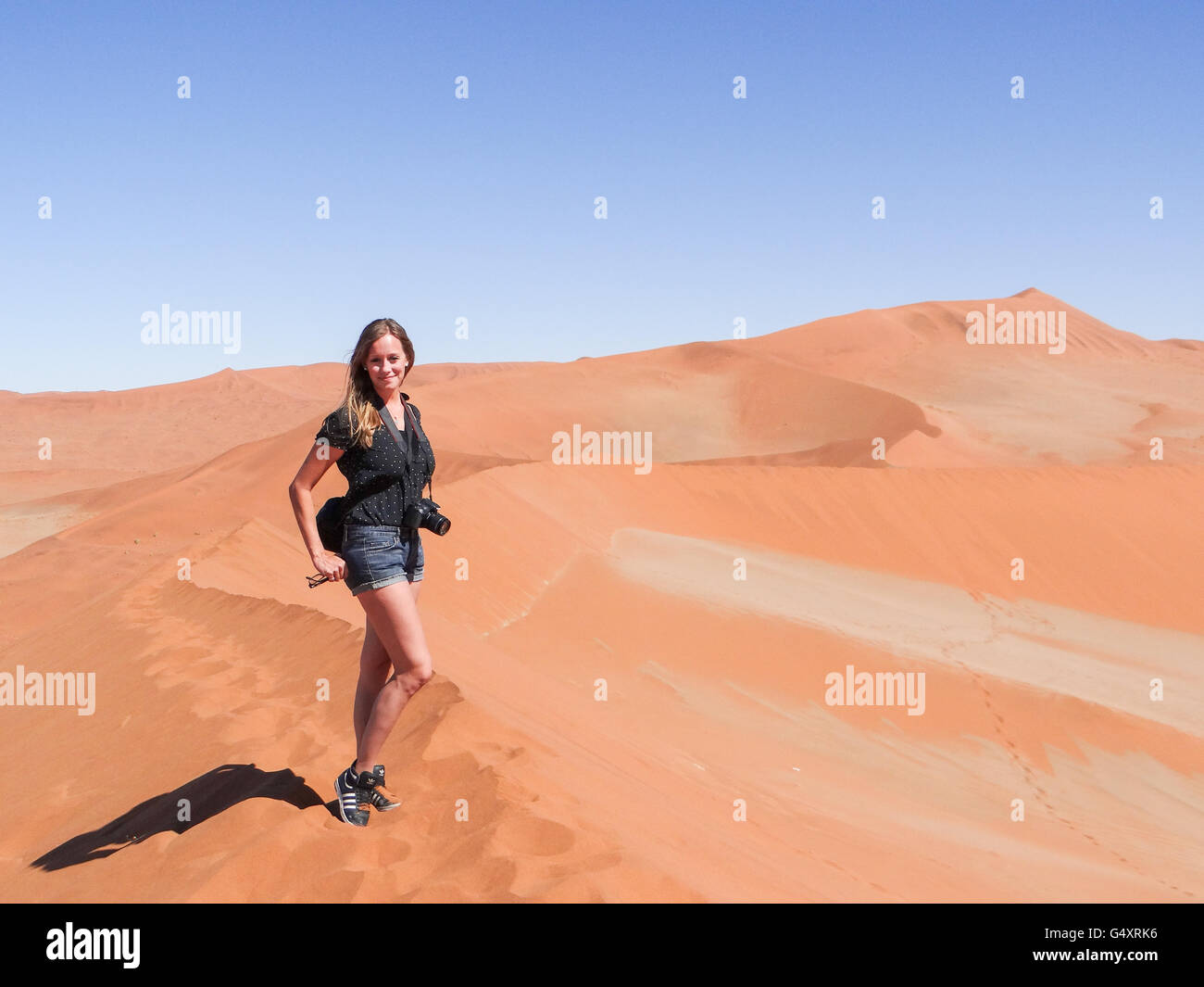 Woman posing on sand dune hi-res stock photography and images - Alamy