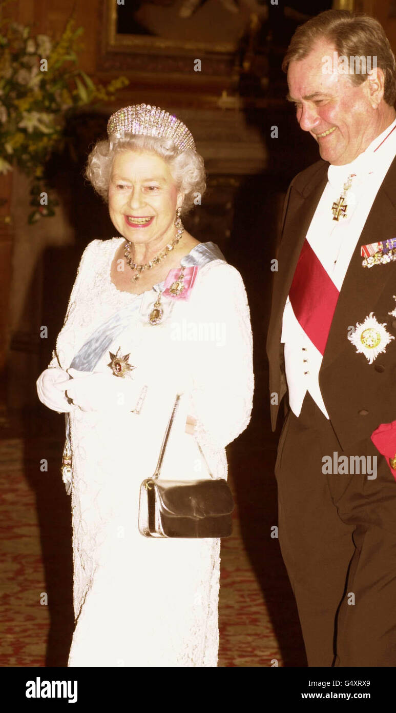 Queen Elizabeth II is accompanied by Prince Henrik of Denmark into