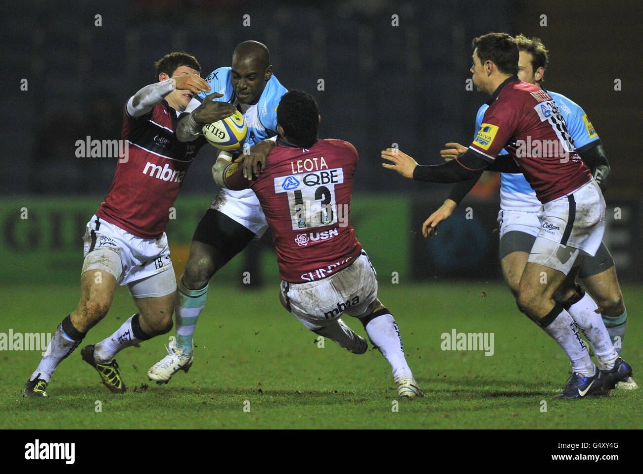 Worcesters Miles Benjamin is tackled by Sale Sharks Johnny Leota and Tom Brady during the Aviva Premiership match at Edgeley Park, Sale. Stock Photo