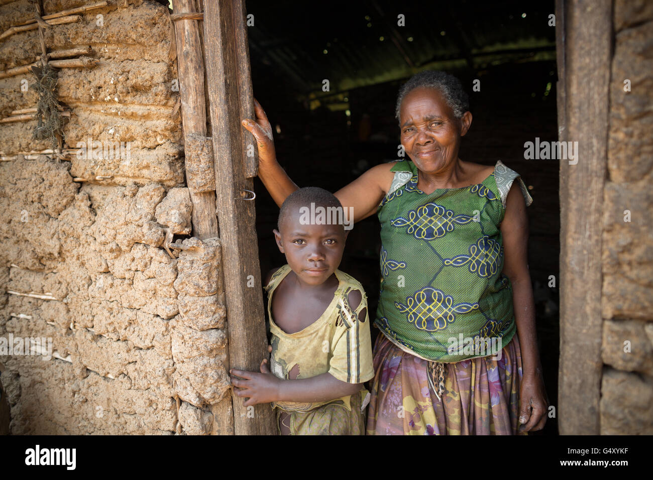 A mother and child stand together in the doorway of their home in rural Kasese District, Uganda. Stock Photo