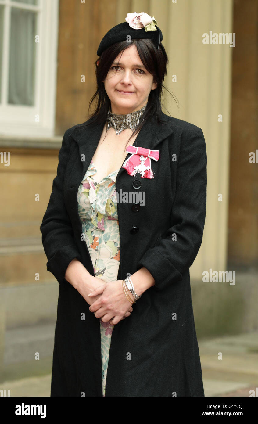Shoe designer Emma Hope poses with her Member of the British Empire (MBE)  medal outside Buckingham Palace in central London Stock Photo - Alamy