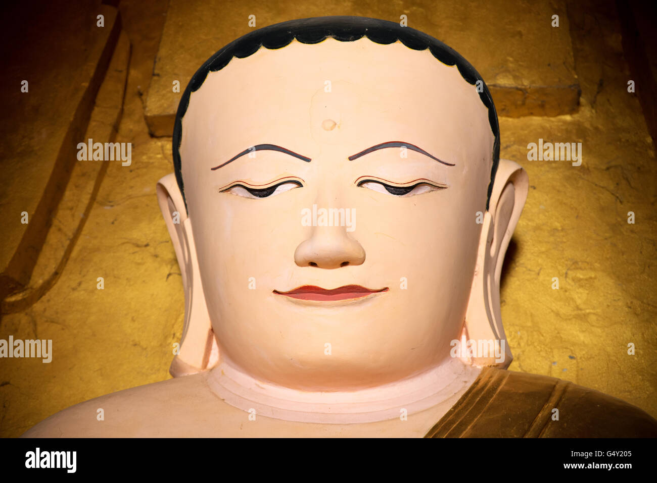 Face of a Buddha sitting statue, Iza Gawna Pagoda, Old Bagan Archaeological Zone, Myanmar Stock Photo
