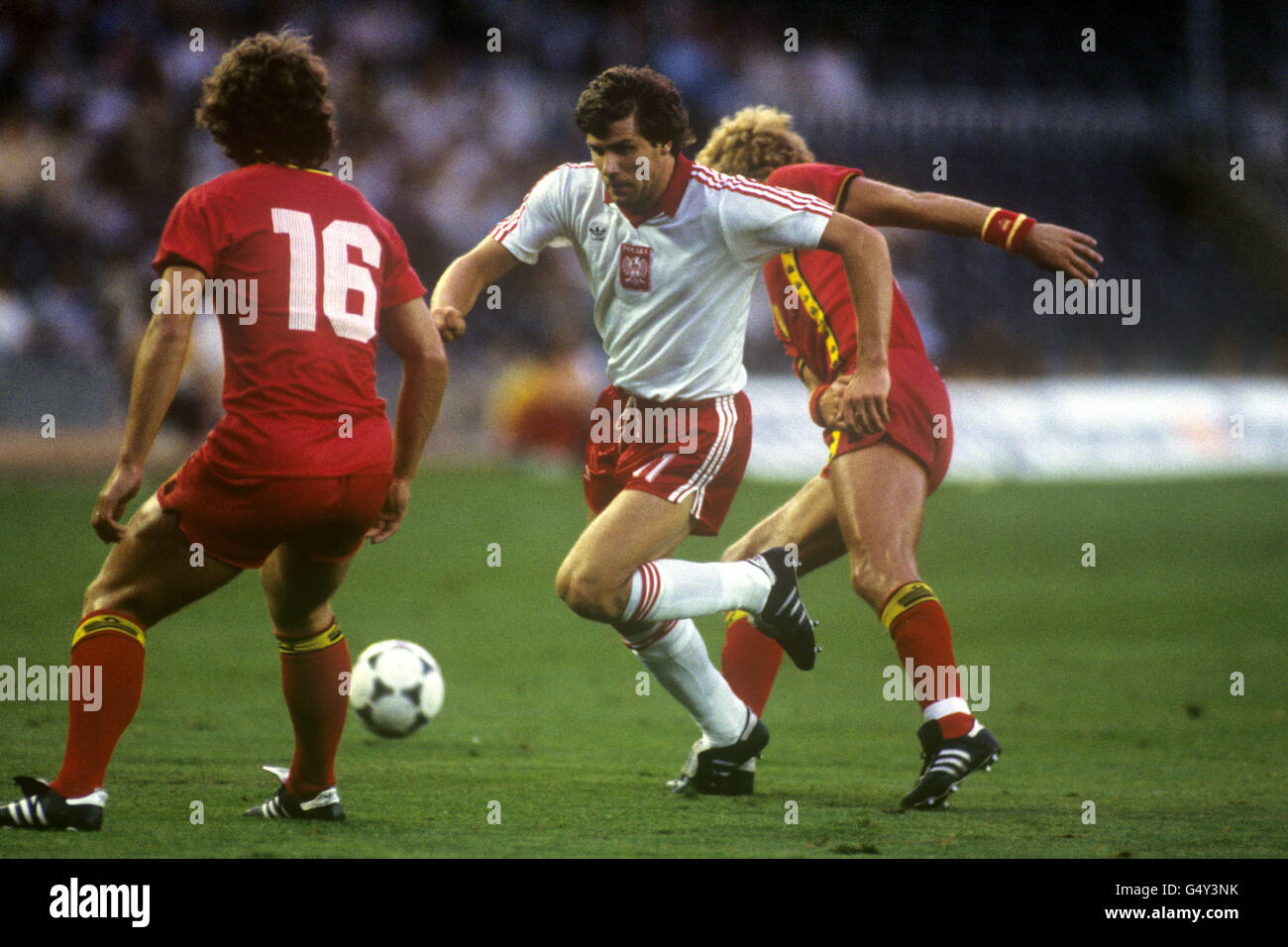 Soccer - FIFA World Cup Spain 82 - Second Round - Group A - Poland v Belgium - Camp Nou, Barcelona. Poland's Wlodimierz Smolarek gets between Belgium's Gerard Plessers (l) and Ludo Coeck (r). Stock Photo