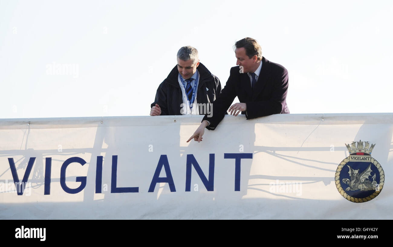 Prime Minister David Cameron boards HMS Vigilant, a Vanguard Class nuclear submarine with Gavin Leckie, Operations Director of Babcock Marine in Plymouth today. Stock Photo