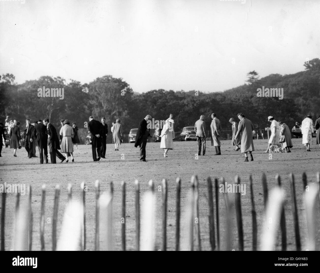 Queen Elizabeth II, centre, joining in with other spectators in treading down the divots at Smith's Lawn, Windsor Great Park. Stock Photo