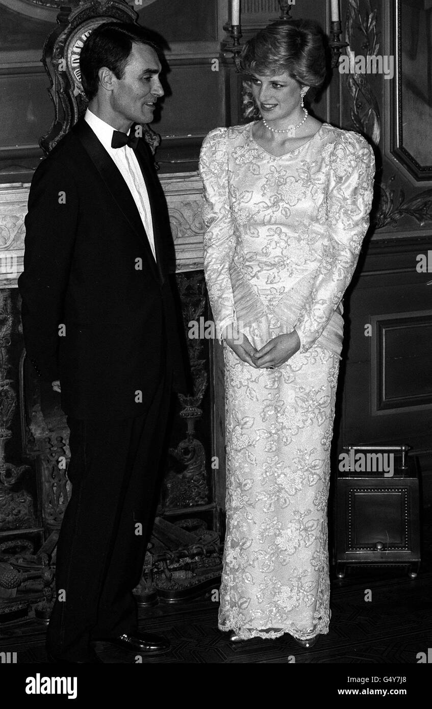 DIANA'S DRESSES: The Princess of Wales chats with Portuguese Prime Minister Anibal Cavaco Silva, at a banquet at the Stock Exchange Palace in the Northern Portuguese City of Oporto. She and Prince Charles were on the third day of their official four day visit to the country. Her dress, by Catherine Walker, was created for the 1986 Royal African Tour but was substantially redesigned circa 1987, reappearing as a sleeveless evening gown with a very low neckline. It was auctioned by Christie's (lot 18), along with 80 other of her dresses, and acquired by Michael R. Lam of Hong Kong. Stock Photo