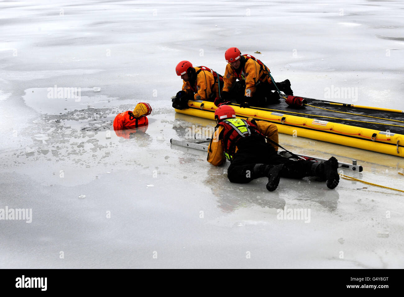 Staff from Malton and Whitby Fire and Rescue Service centres during an exercise in a freezing lake near York, North Yorkshire as arctic blast of snow could hit the UK in the coming days as the big freeze shows no sign of melting away. Stock Photo