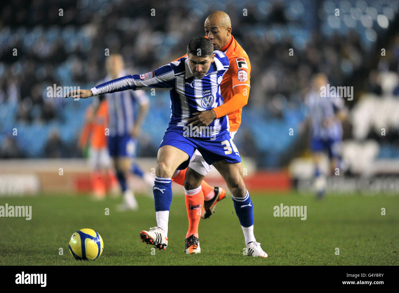 Soccer - FA Cup - Fourth Round Replay - Sheffield Wednesday v Blackpool - Hillsborough. Blackpool's Alex Baptiste and Sheffield Wednesday's Scott Donnelly (left) battle for the ball Stock Photo