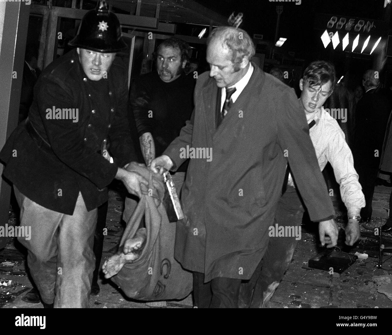 A fireman and rescue workers carry a barefooted body away from the scene of one of the Birmingham pub bombings. Two pubs, The Mulberry and The Tavern in the Town were targeted in the attacks ; at least 19 people died and over 200 were injured. *Many of the victims had their clothes blown off in the blast. 21/11/04: A memorial service is taking place to mark the 30th anniversary of one of mainland Britain's worst terrorist atrocities. Hundreds of people, including survivors, will gather in Birmingham at 4pm to remember the 21 people who died when two bombs ripped through two city centre pubs. Stock Photo