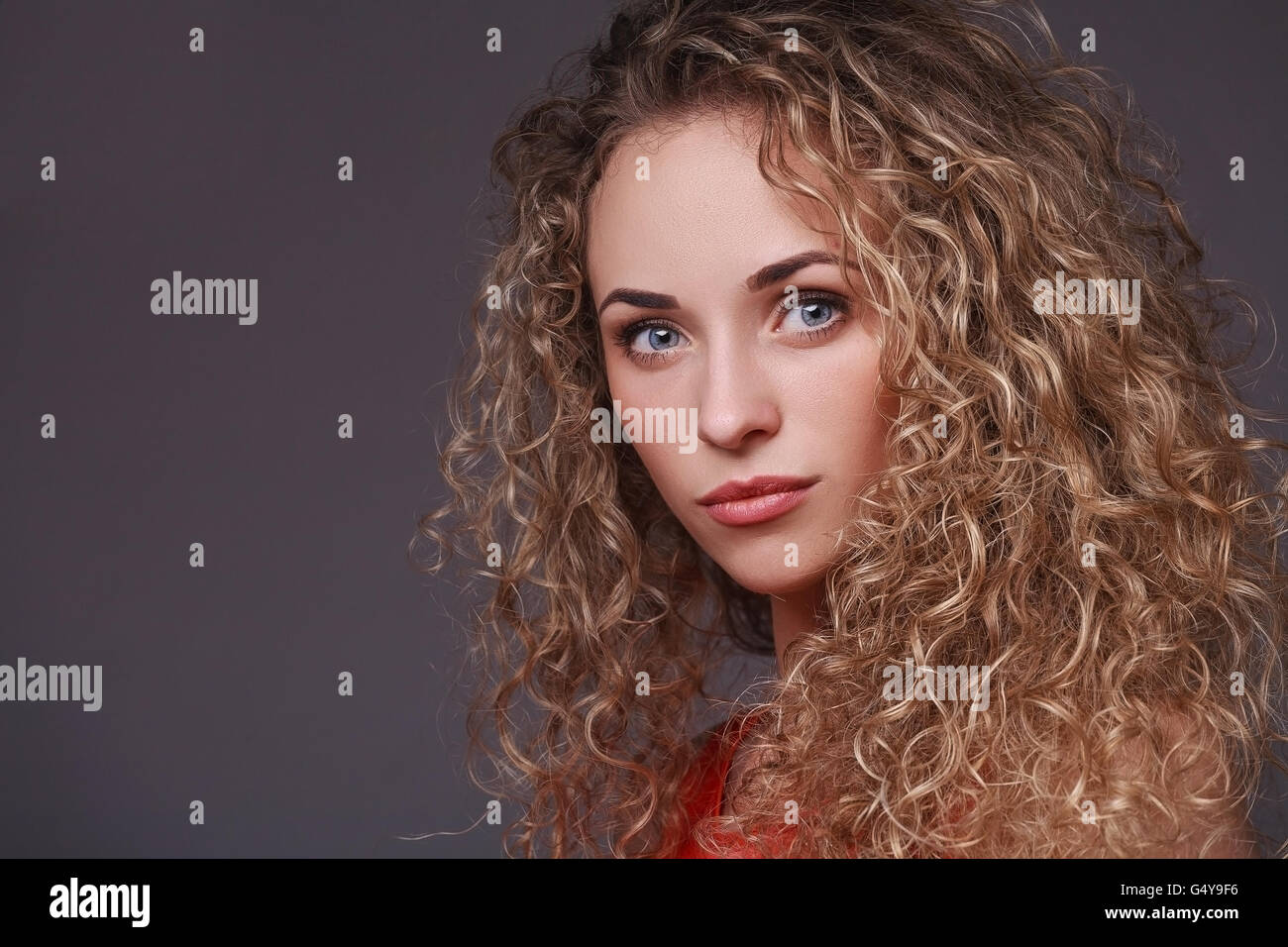 Portrait of woman with curly hair Stock Photo - Alamy