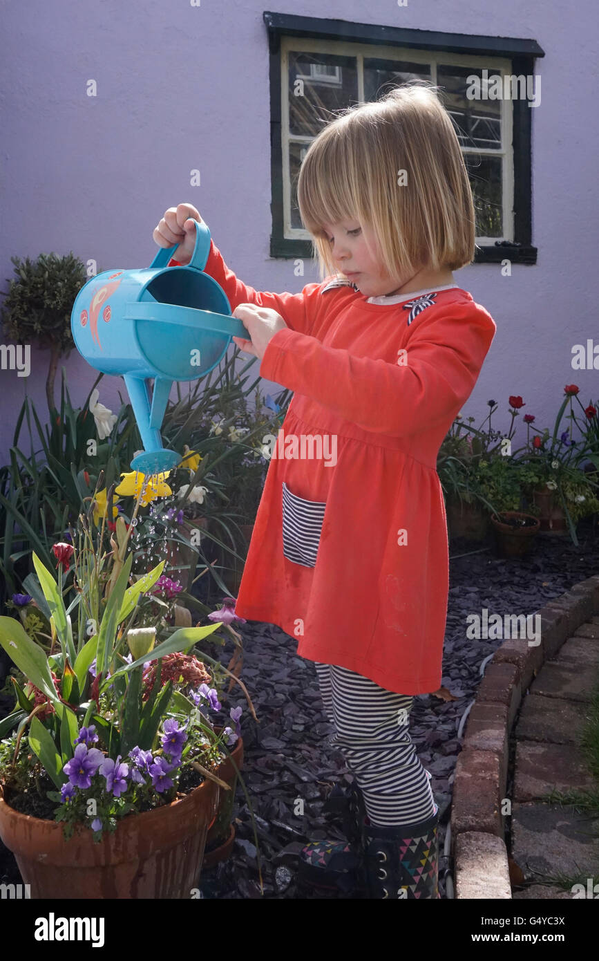 child watering garden with watering can Stock Photo Alamy
