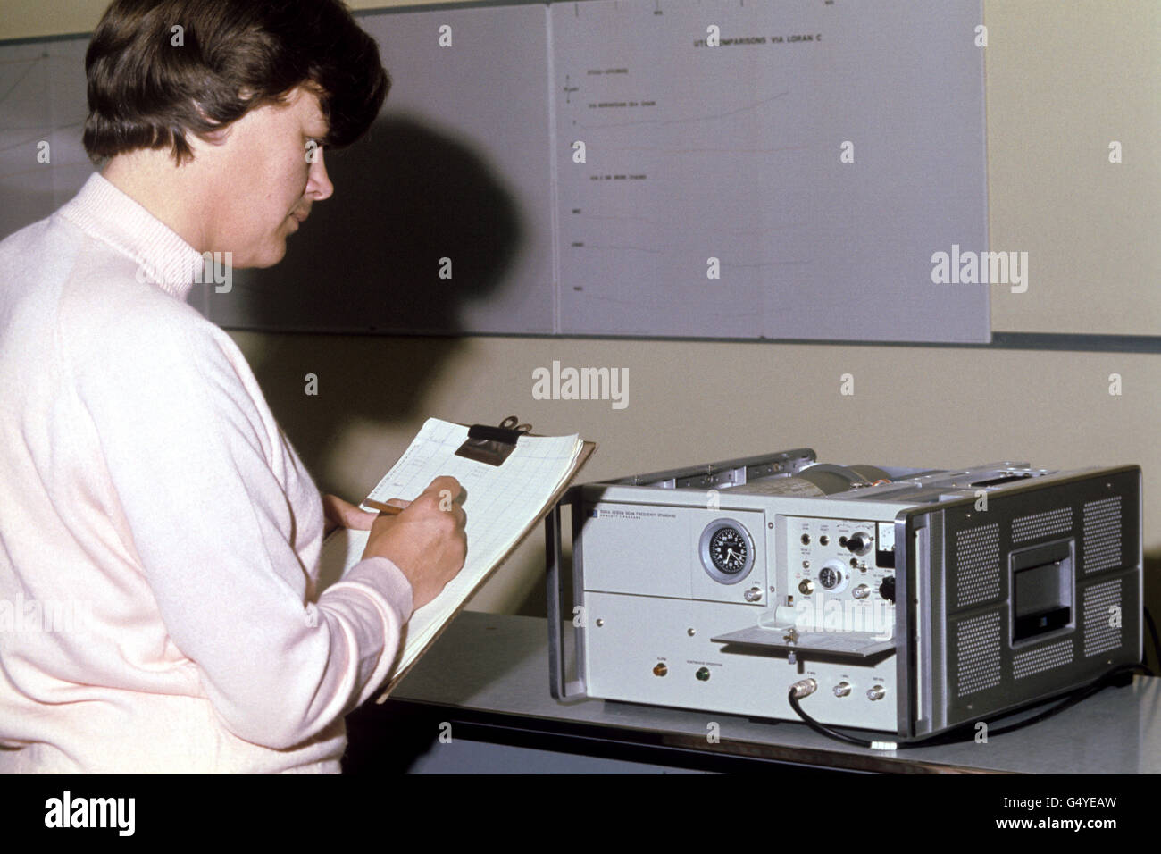 Mrs Anne Strong of Eastbourne checks an atomic clock at the Royal Greenwich Observatory, located near Herstmonceux Castle, East Sussex Stock Photo