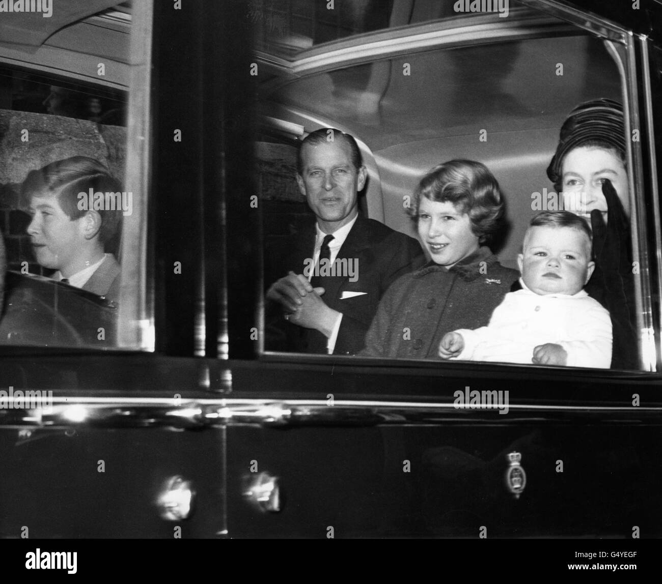 Queen Elizabeth II with baby Prince Andrew, the Prince of Wales, Princess Anne and the Duke of Edinburgh, driving from Liverpool Street Station on their return to London from Sandringham. Stock Photo