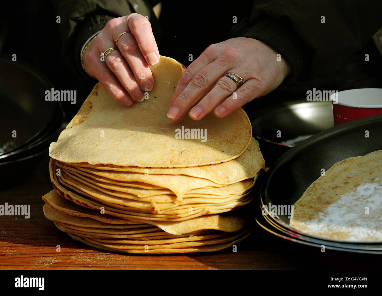 Organizers prepare pancakes for staff and students at the University of Sheffield prior to The Big Flip, an attempt to break the Guinness World Record for the most people flipping pancakes at The Endcliffe Village, Sheffield. Stock Photo