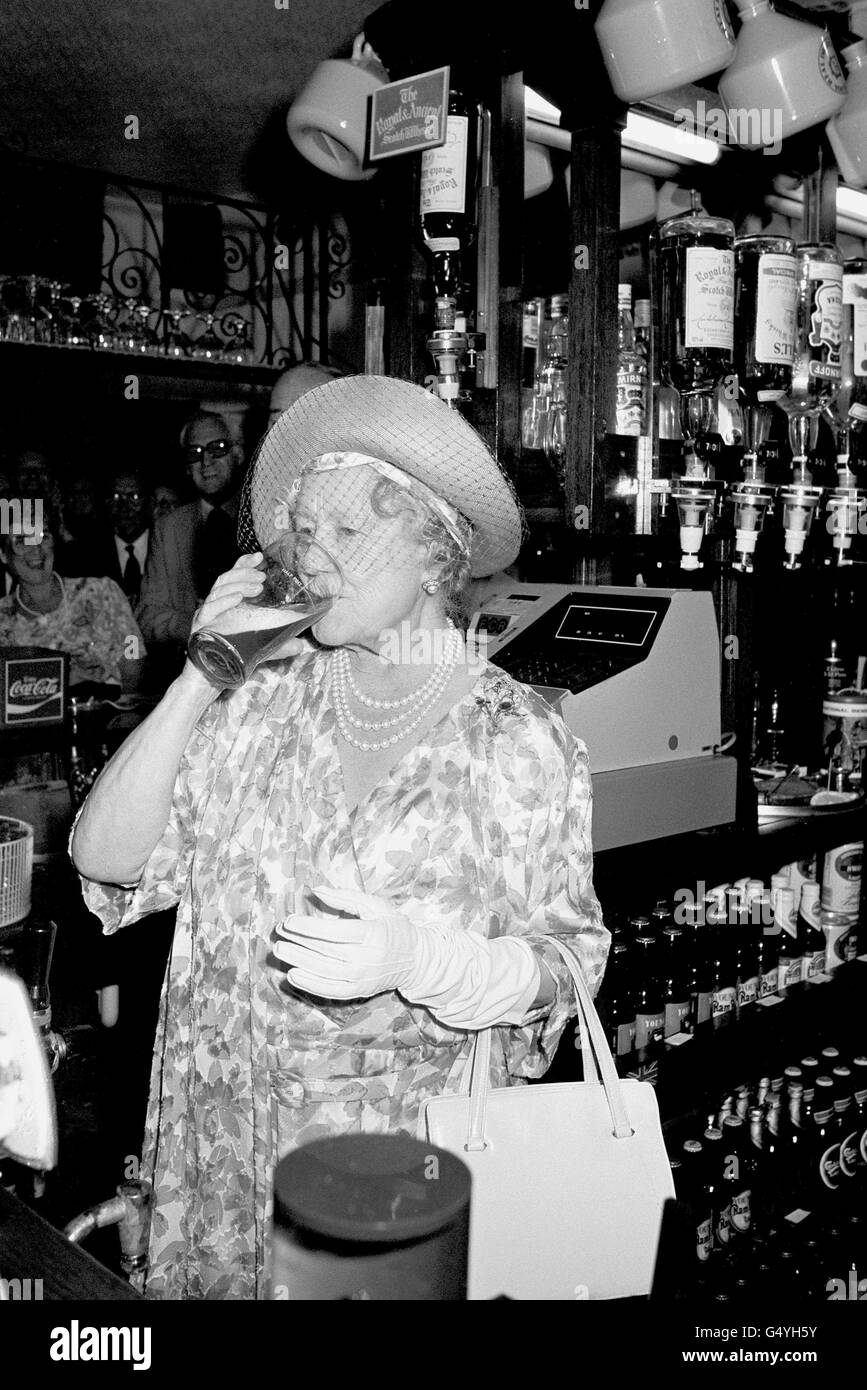 Queen Mother Drinking Pint Stock Photo