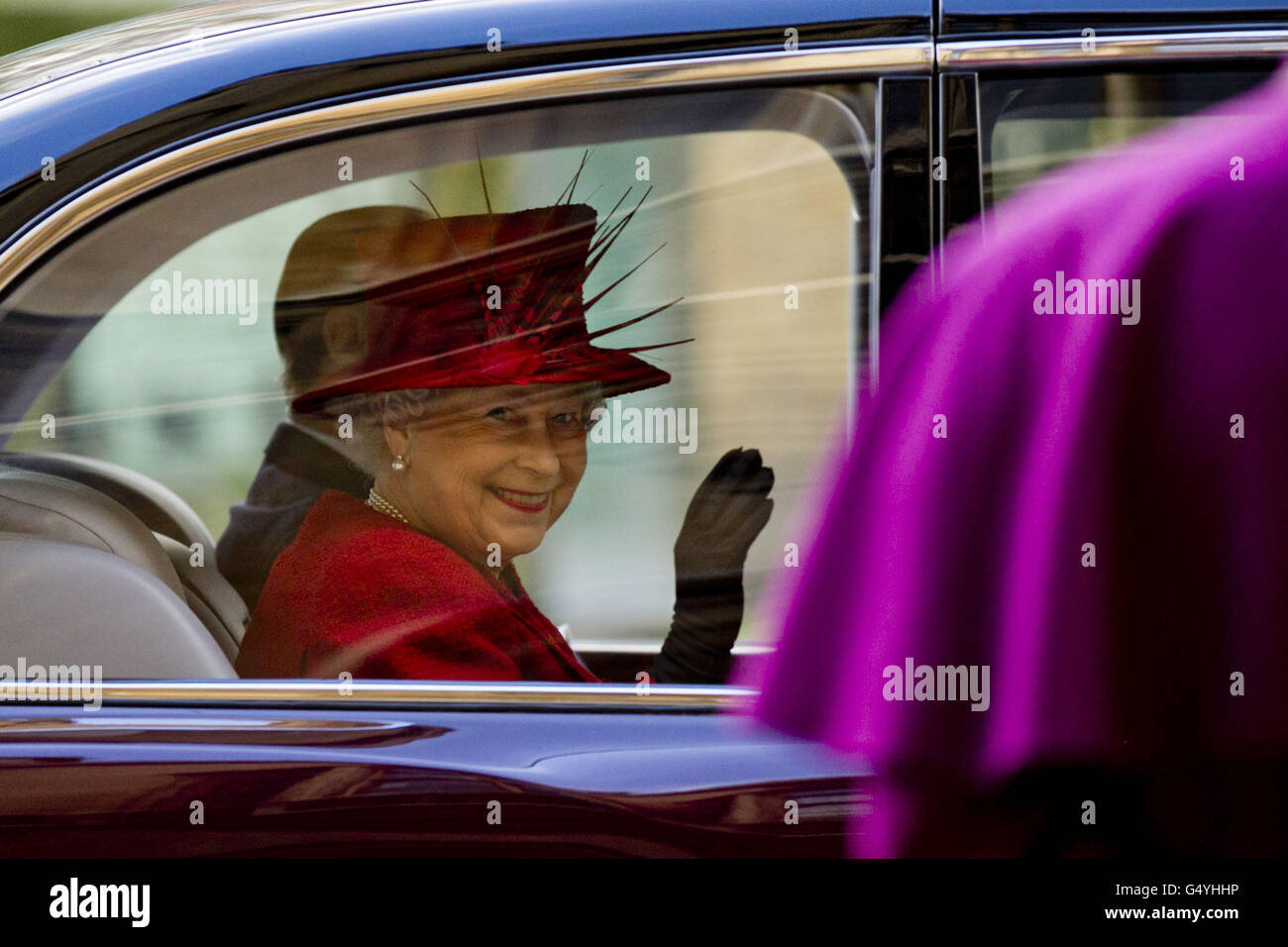 Queen Elizabeth II waves goodbye to the Archbishop of Canterbury, Dr Rowan Williams as she is driven away after attending a multi-faith reception to mark the Diamond Jubilee of the Queen's Accession at Lambeth Palace in London. Stock Photo