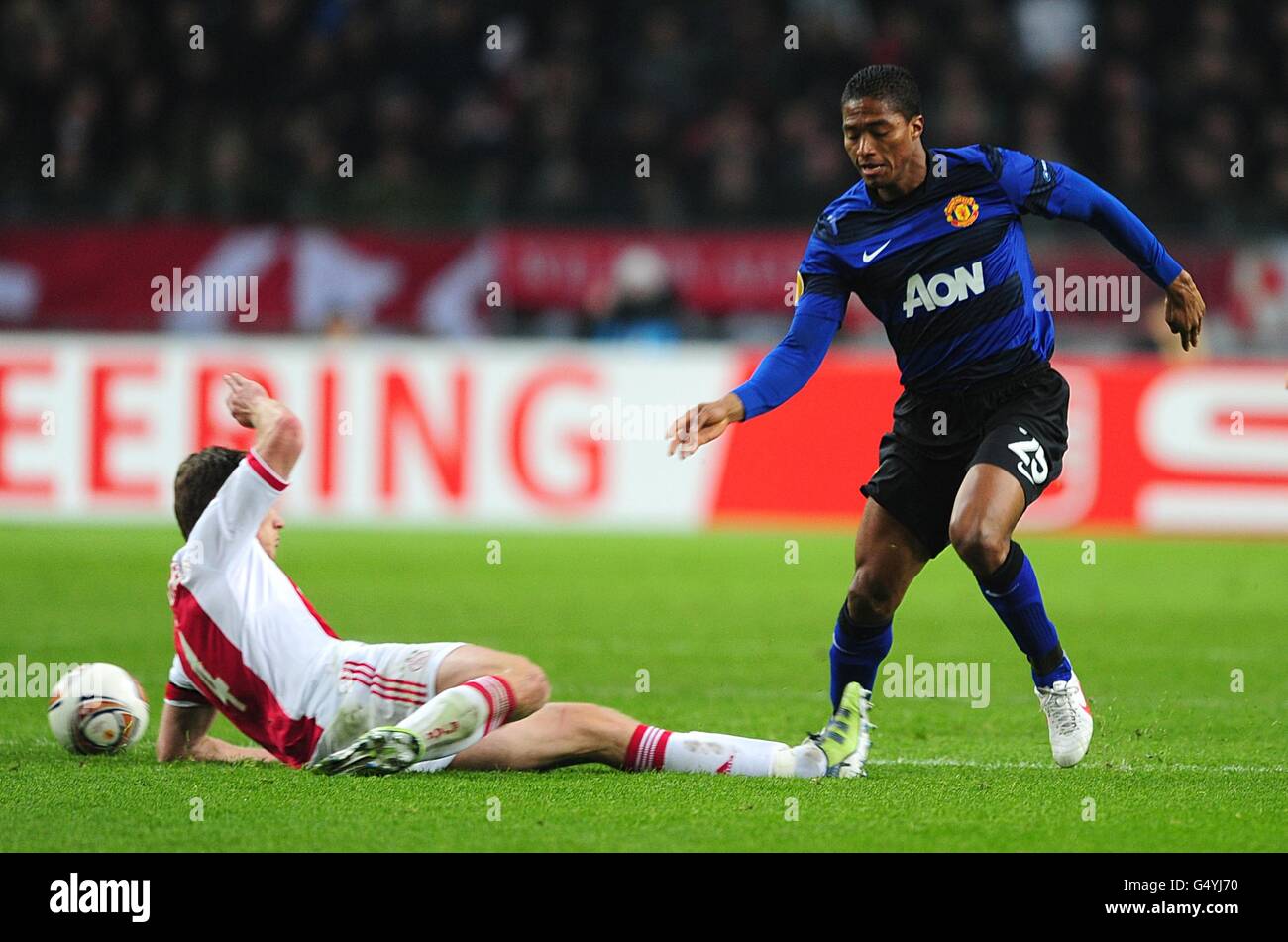 Manchester United's Antonio Valencia (right) is brought down by Ajax's Jan Vertonghen in the build up to United's second goal Stock Photo