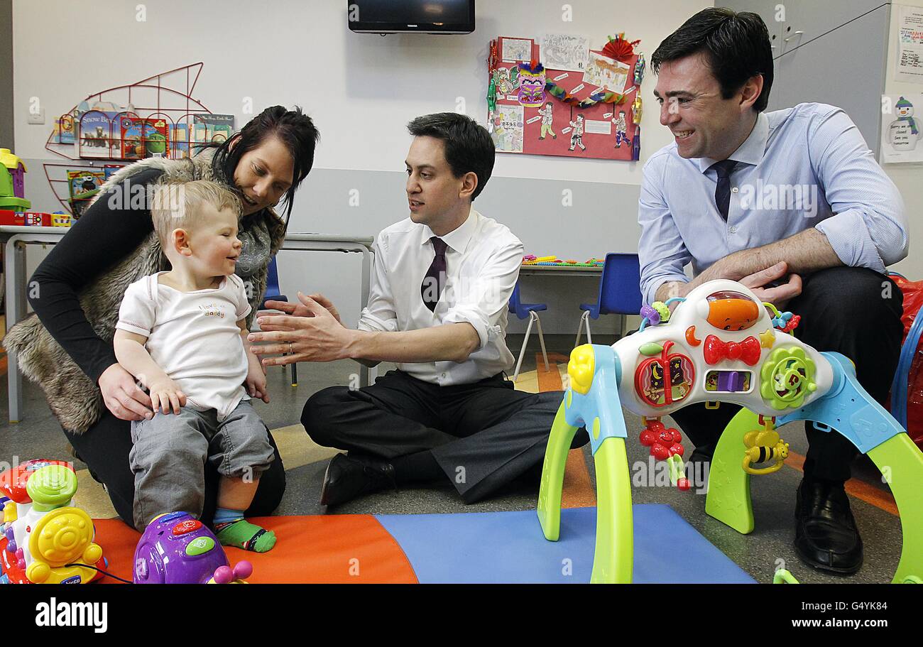 Labour leader Ed Miliband and shadow health secretary Andy Burnham meet 16-month-old Marley Richardson and his mother Carla Toner during a visit to the Royal Bolton Hospital in Greater Manchester. Stock Photo