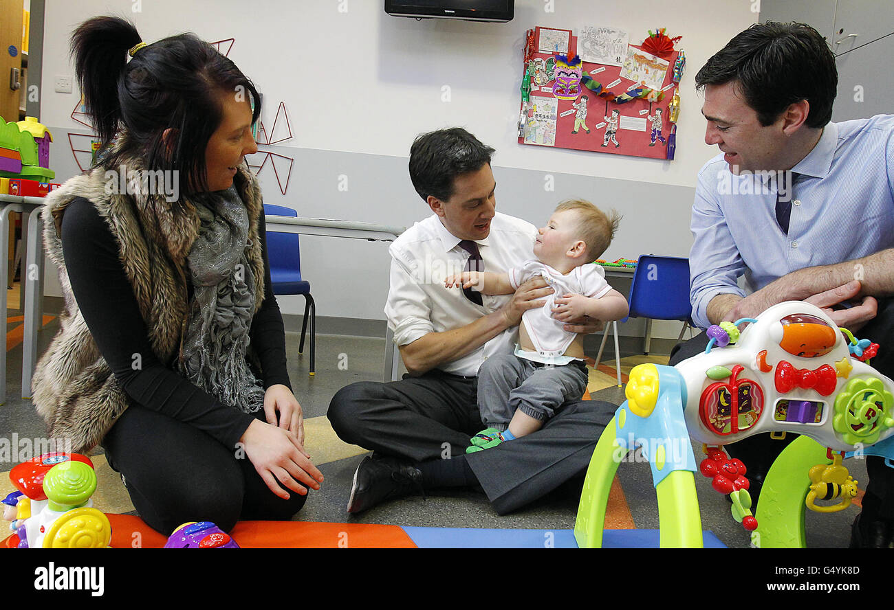Labour leader Ed Miliband and shadow health secretary Andy Burnham meet 16-month-old Marley Richardson and his mother Carla Toner during a visit to the Royal Bolton Hospital in Greater Manchester. Stock Photo