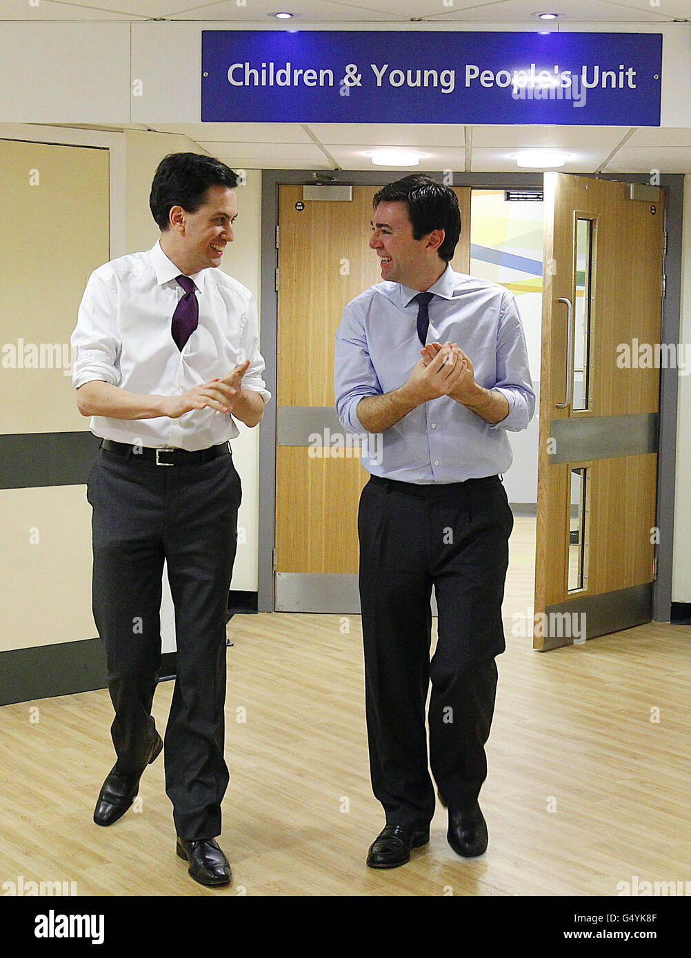 Labour leader Ed Miliband (left) and shadow health secretary Andy Burnham talk during a visit to the Royal Bolton Hospital in Greater Manchester. Stock Photo