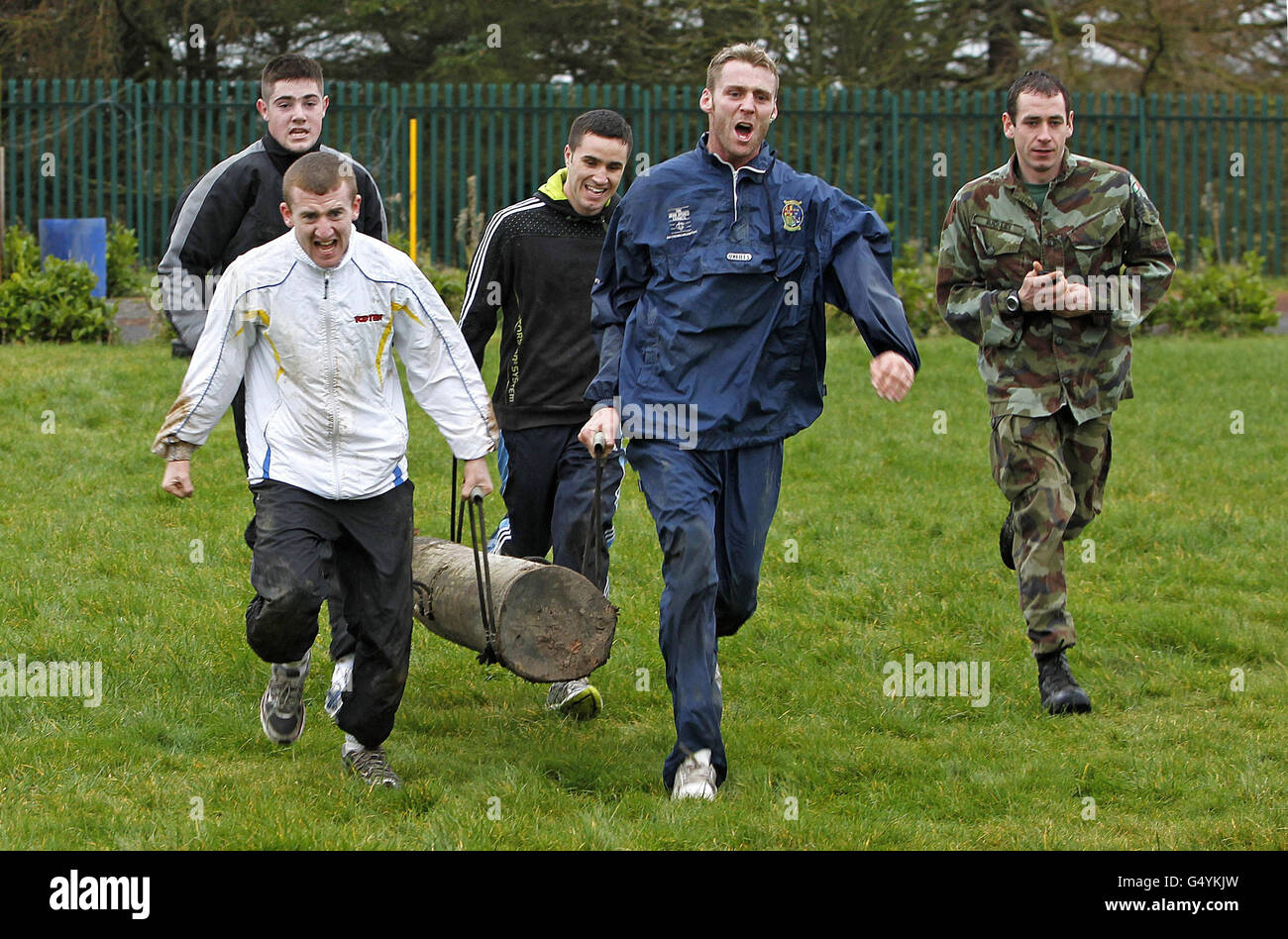 Irish Boxing Team members including Paddy Barnes (front left), Joe Ward (rear left), Roy Sheehan (front right) and David Oliver Joyce carry logs during the Irish Defence Forces endurance and team building assault course at the Curragh Army Camp, Curragh. Stock Photo