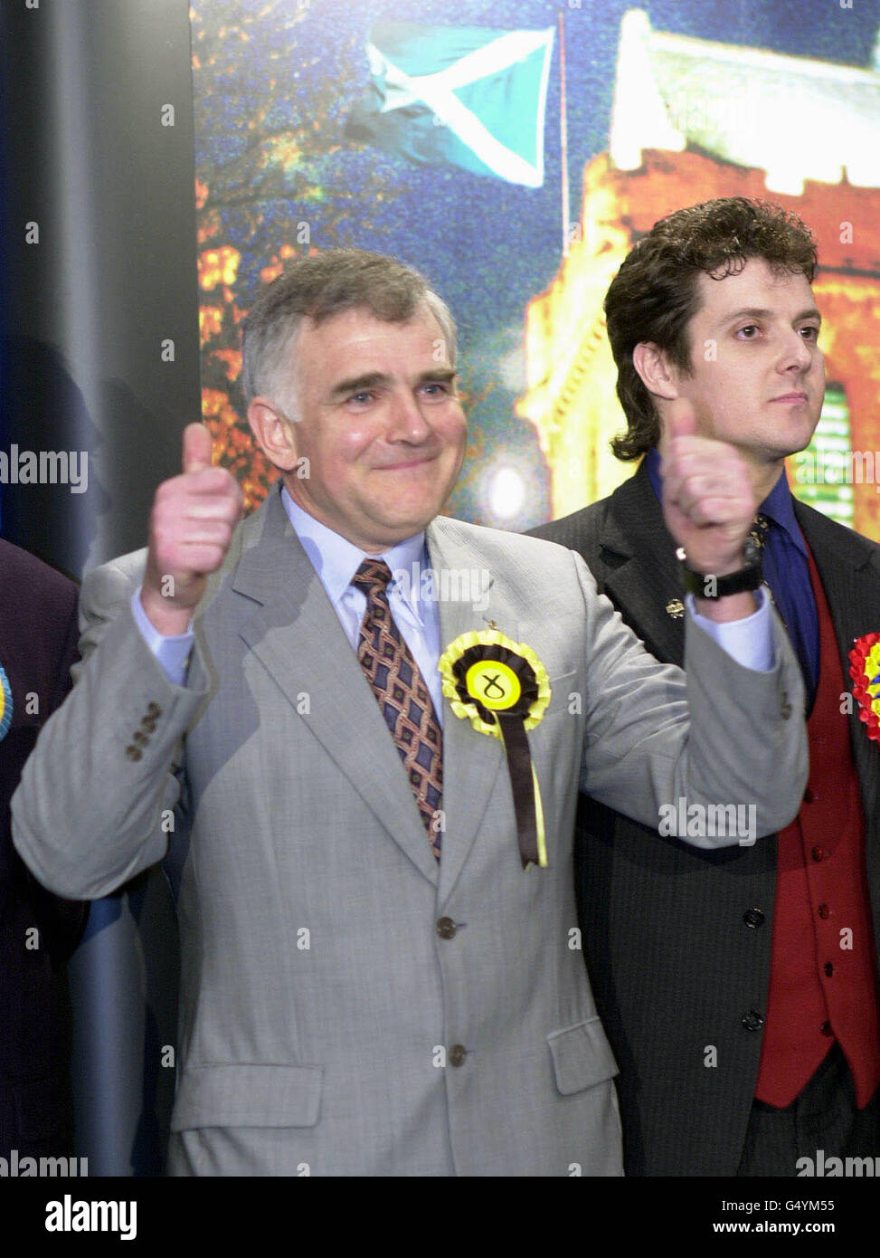 Scottish National Party candidate Jim Mather celebrates as Labour is forced into third place, and UK Independence Party candidate Alistair McConnachie (right) looks on as the result for the Ayr by-election is announced at the Citadel Leisure Centre in Ayr. Stock Photo