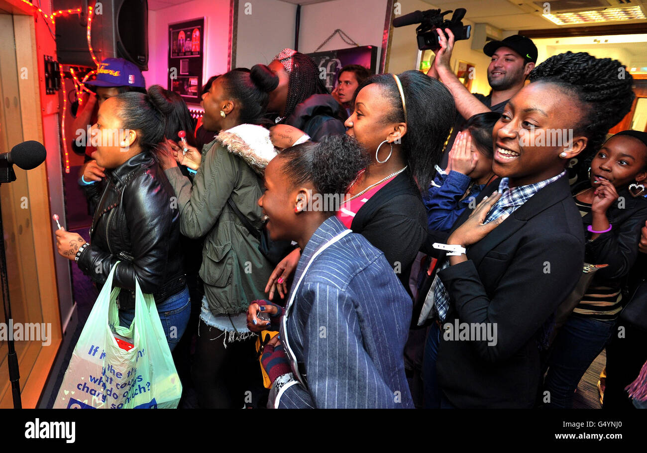 Fans of the new American pop band Mindless Behavior, watch during a live performance in the ChoiceFM studio Leicester Square in central London. Stock Photo