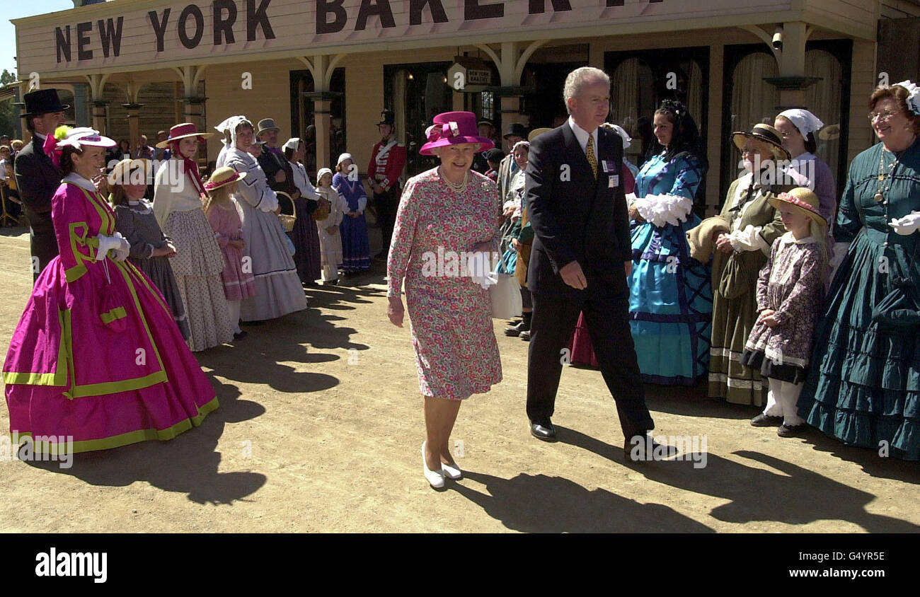 Queen Elizabeth II, accompanied Gerard Ballantyne, chairman of Ballarat Tourist Board, walks the main street of Sovereign Hill, a reconstructed 1850's gold rush town near Ballarat, Victoria. Thousands turned out to see the Queen visit the former boom town. * when gold was discovered in 1851. Stock Photo