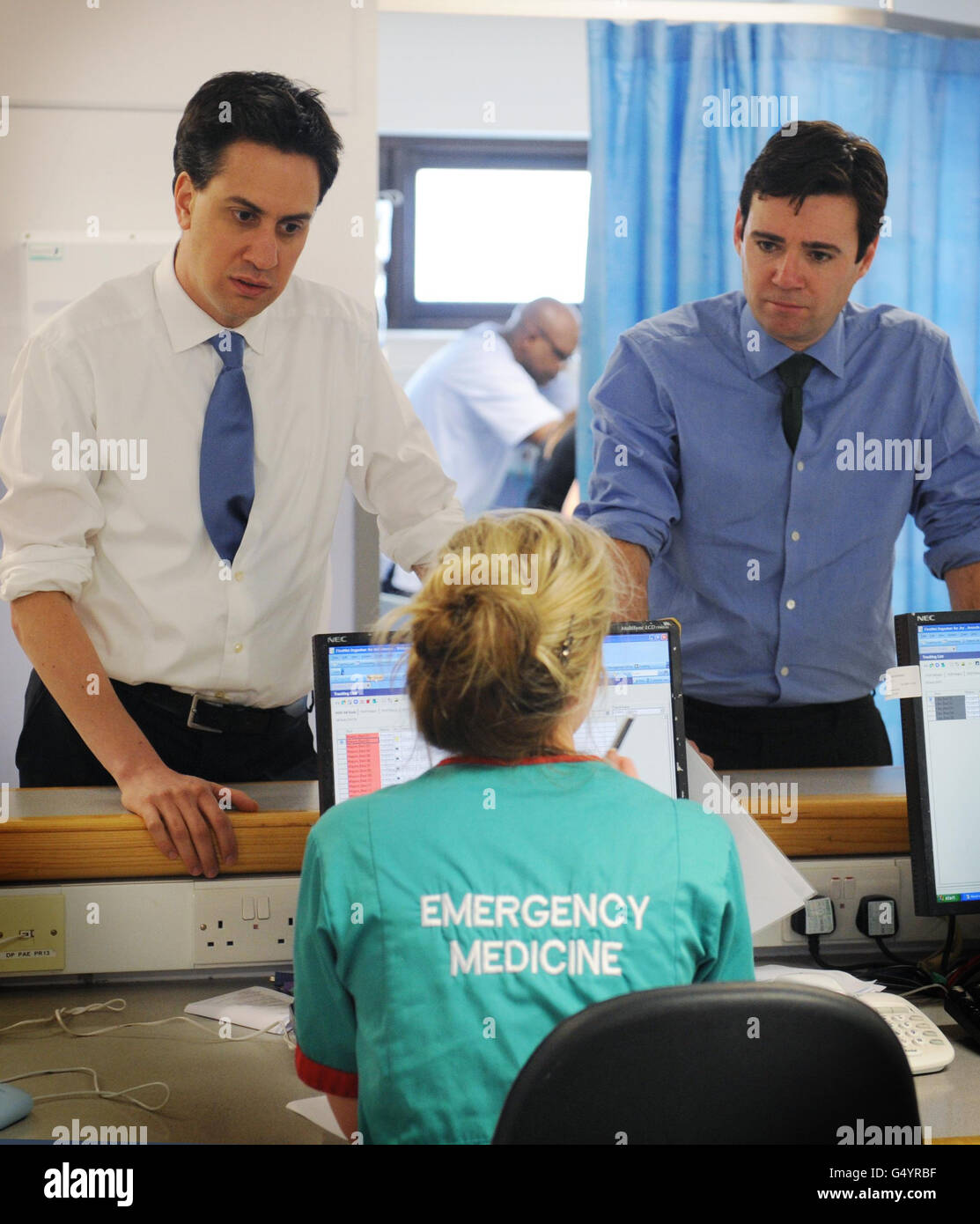 Labour leader Ed Miliband and shadow health secretary Andy Burnham (right) meet staff during a visit to the Homerton Hospital in Hackney, east London. Stock Photo